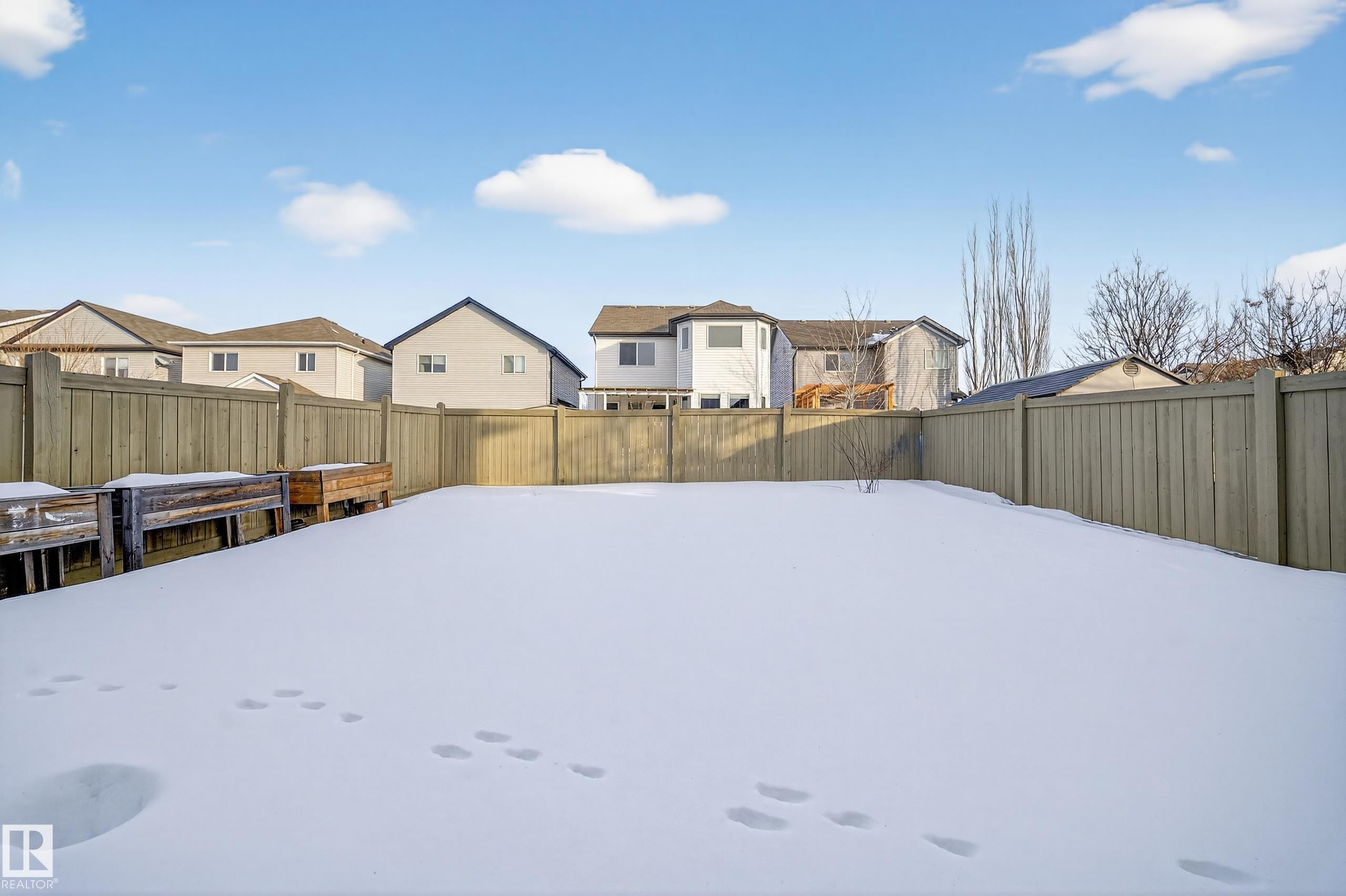 Snowy yard with a residential view and a fenced backyard - 1741 63A Street, Edmonton, AB