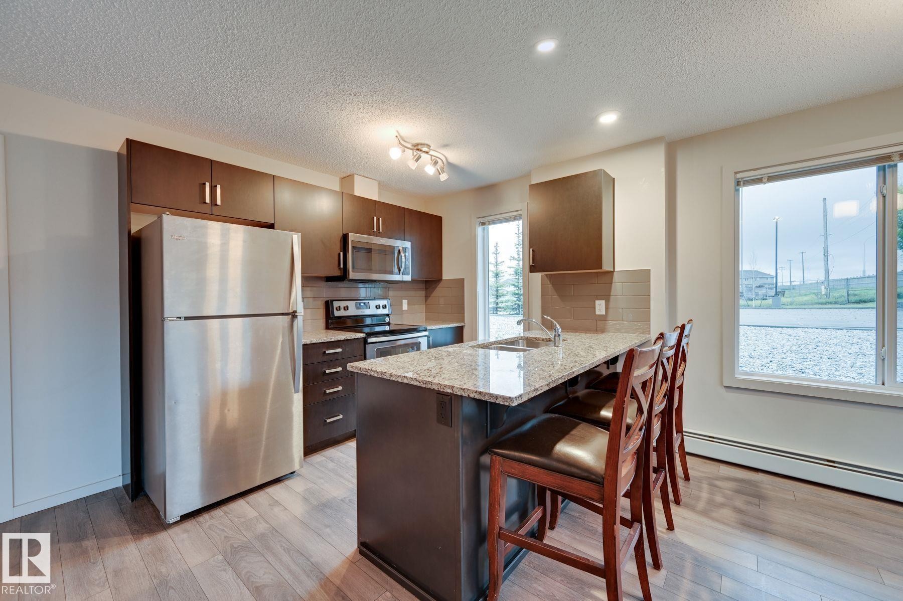 101 142 Ebbers Boulevard, Edmonton, AB - Indoor Photo Showing Kitchen With Stainless Steel Kitchen With Double Sink