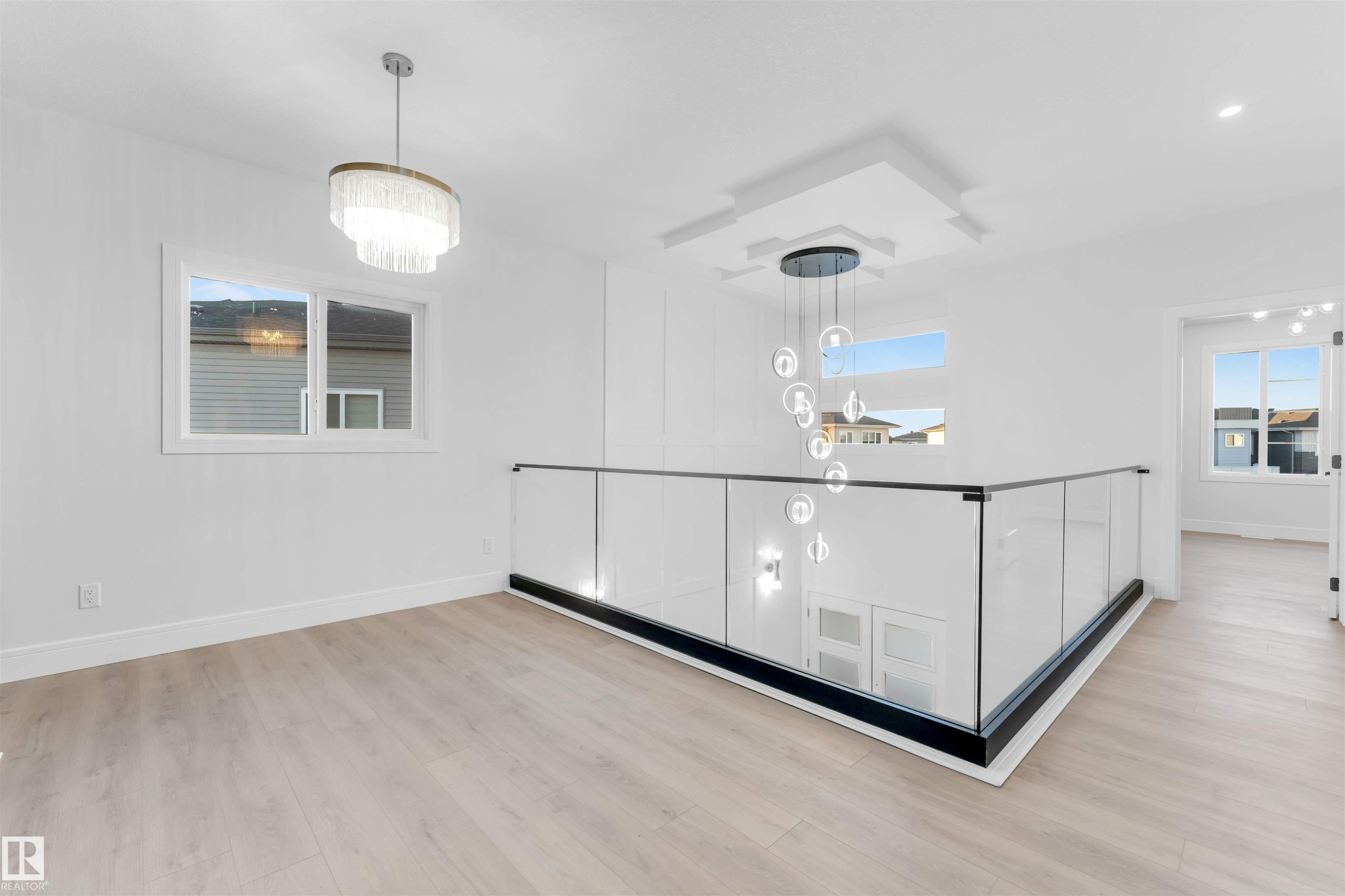 Unfurnished dining area featuring light wood-type flooring and a chandelier - 150 Creekside Lane, Leduc, AB - Indoor Photo Showing Other Room