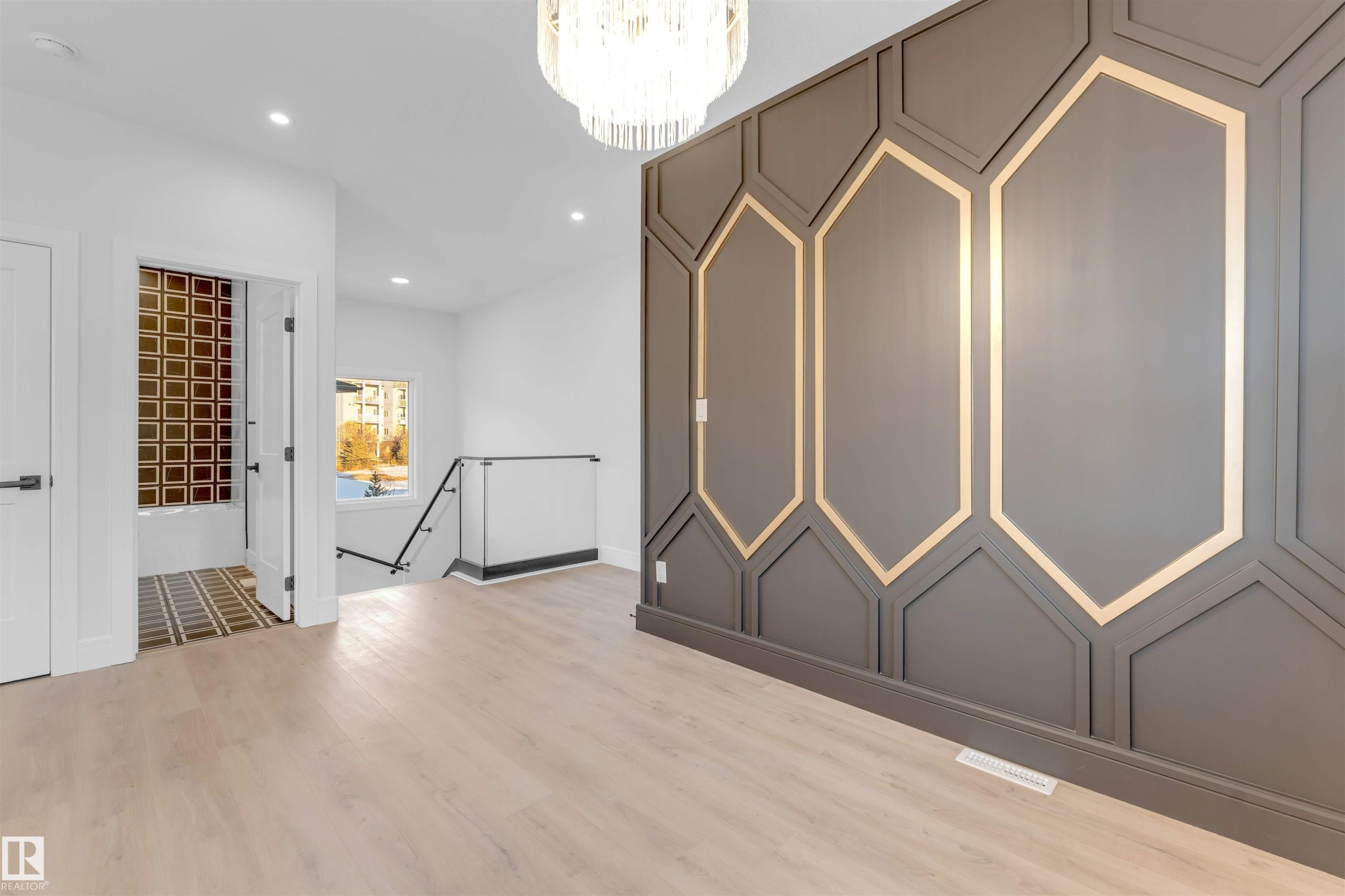 Spare room featuring recessed lighting, a chandelier, and light wood finished floors - 150 Creekside Lane, Leduc, AB - Indoor Photo Showing Other Room