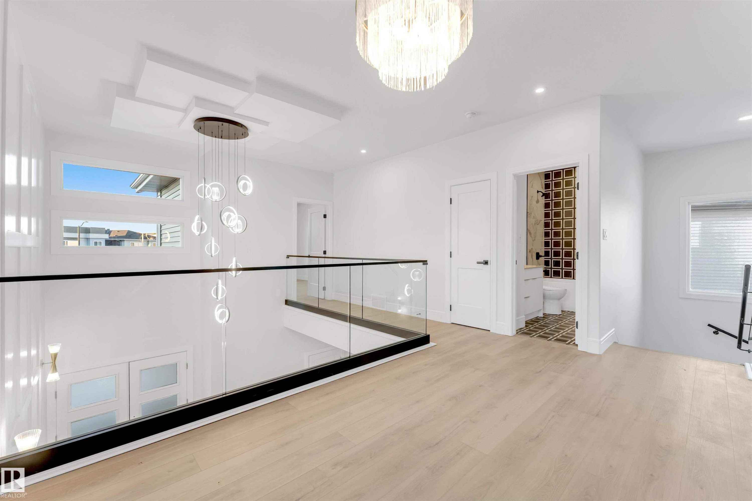 Hallway with a chandelier, an upstairs landing, light wood-type flooring, and recessed lighting - 150 Creekside Lane, Leduc, AB - Indoor Photo Showing Other Room