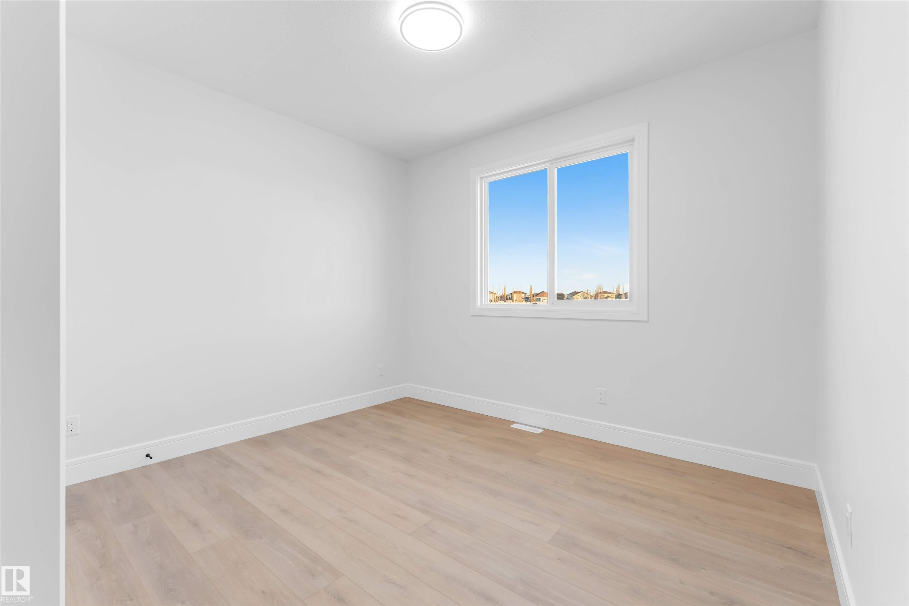 Unfurnished room with light wood-style floors and baseboards - 150 Creekside Lane, Leduc, AB - Indoor Photo Showing Other Room
