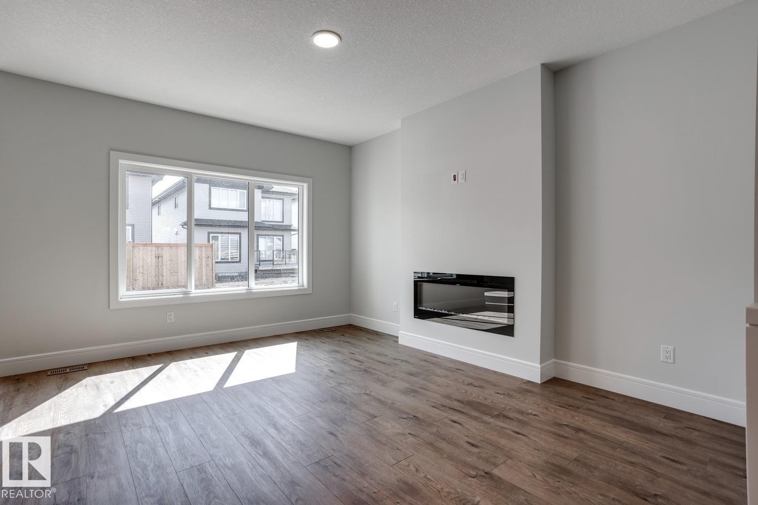 405 Brickyard Point(E), Stony Plain, AB - Indoor Photo Showing Living Room With Fireplace