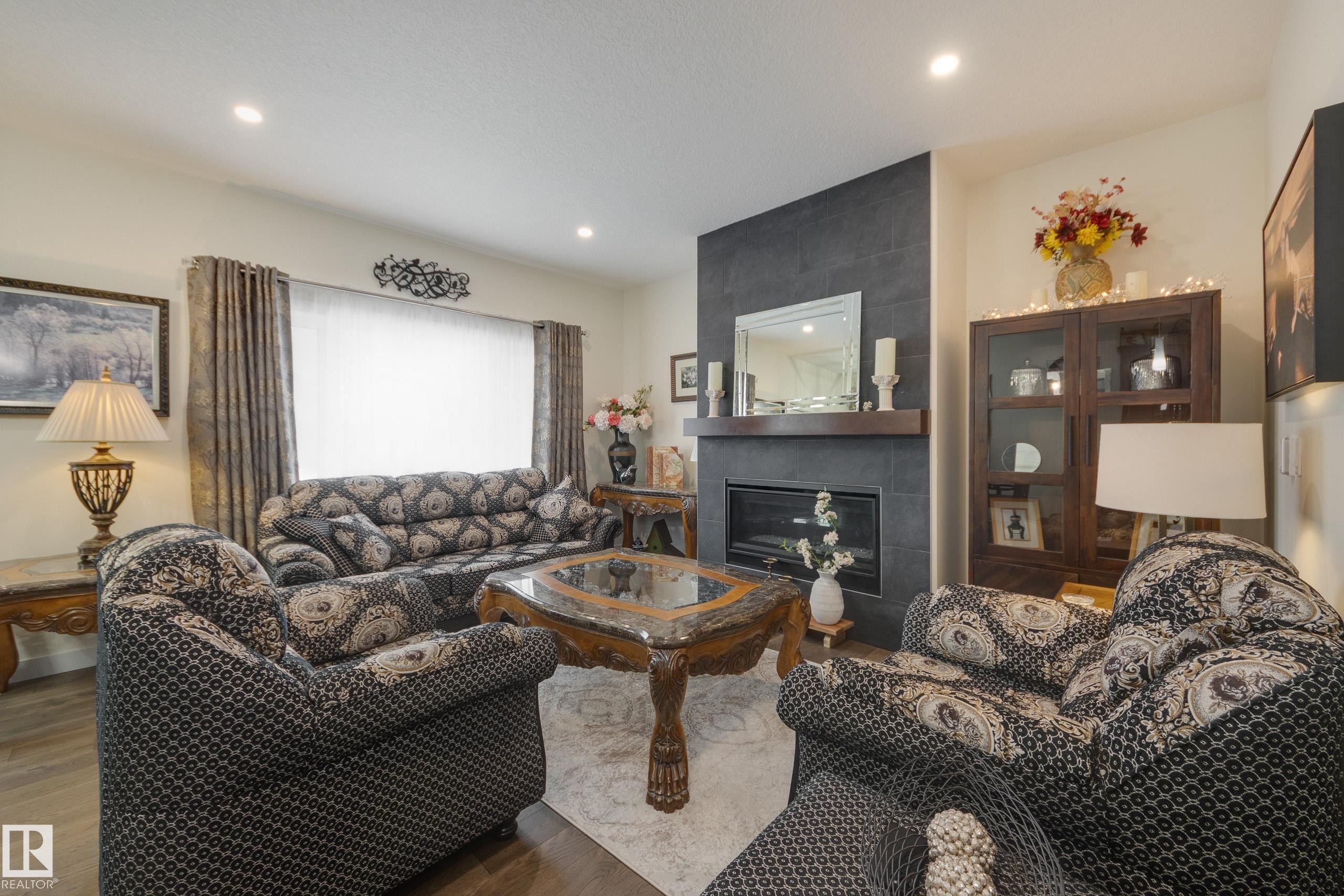 64 Maple Crescent, Gibbons, AB - Indoor Photo Showing Living Room With Fireplace