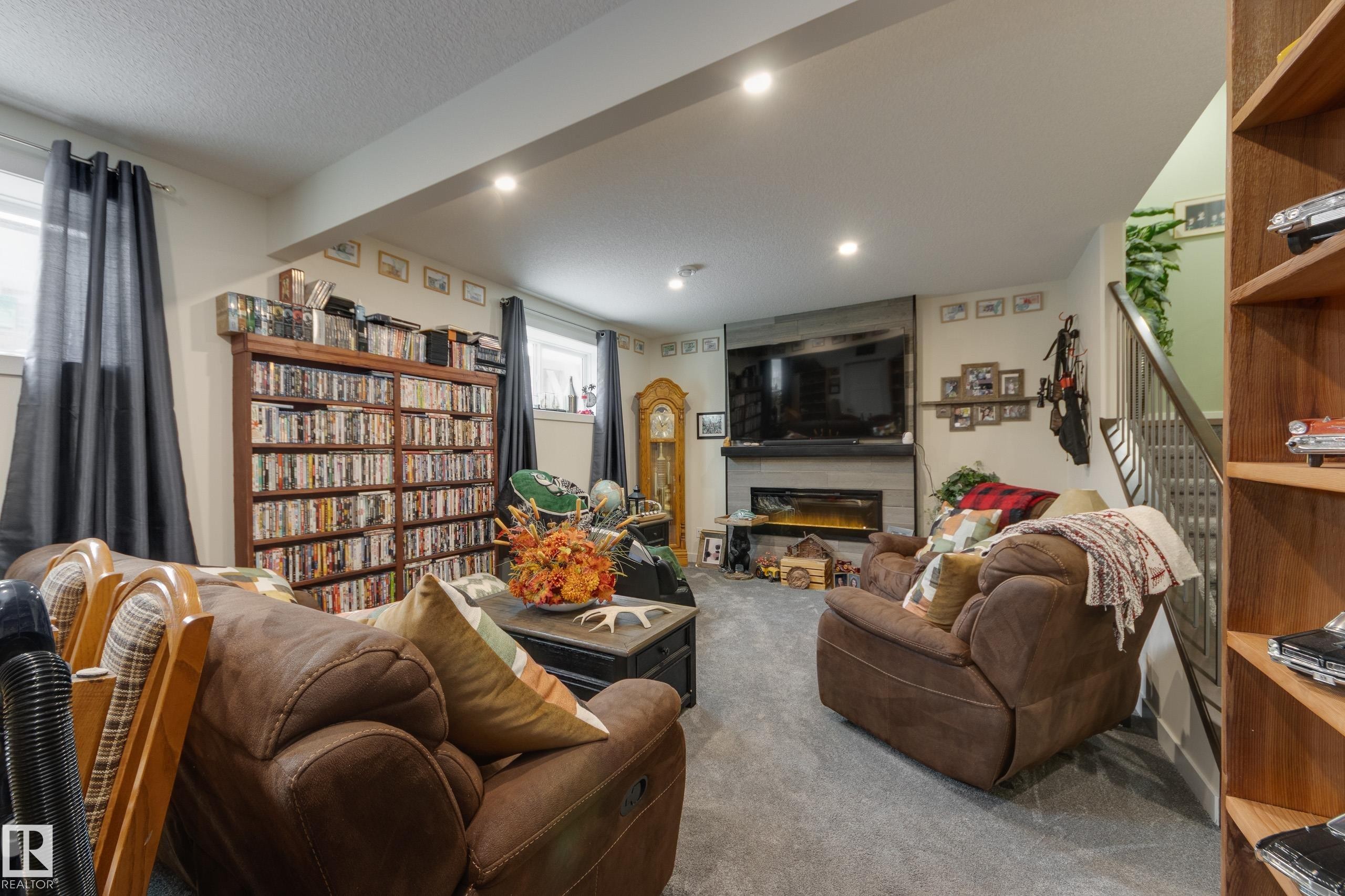 64 Maple Crescent, Gibbons, AB - Indoor Photo Showing Living Room With Fireplace