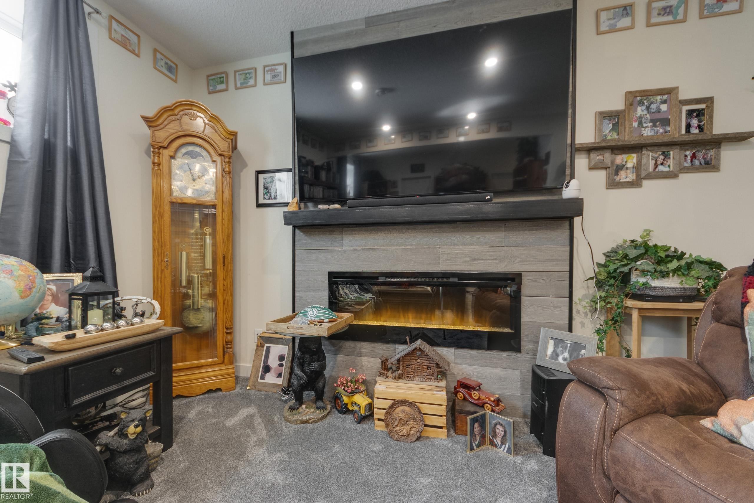 64 Maple Crescent, Gibbons, AB - Indoor Photo Showing Living Room With Fireplace