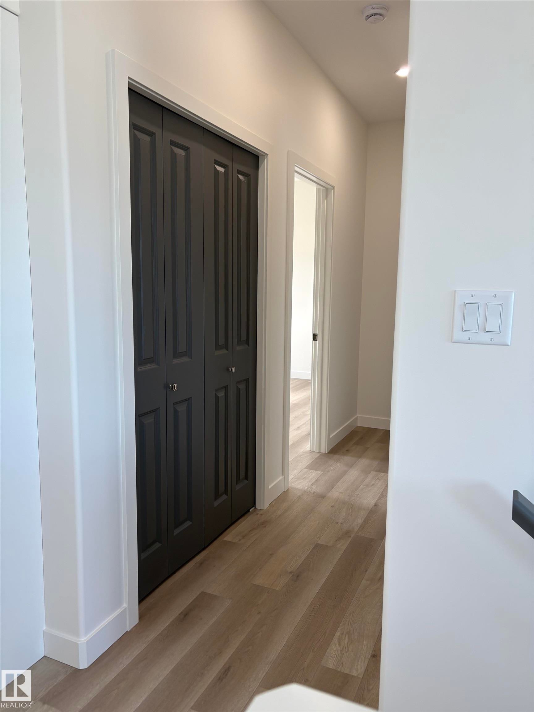 Hallway featuring light wood-finish flooring and recessed lighting - 6 4 Avenue, Hay Lakes, AB