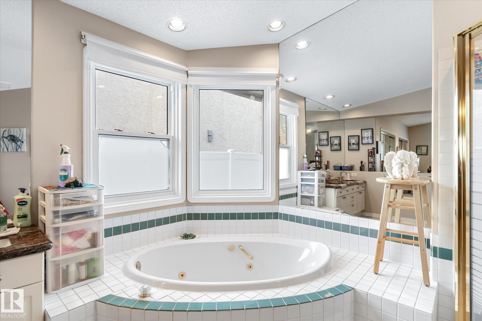 Full bath featuring vanity, a tub with jets, recessed lighting, and a textured ceiling - 7020 157 Avenue, Edmonton, AB - Indoor Photo Showing Bathroom