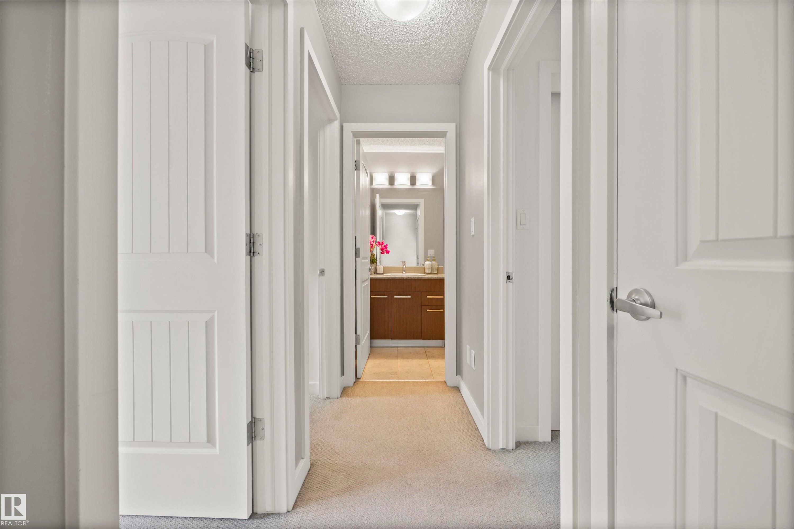 Hallway featuring light carpet and a textured ceiling - 56 655 Watt Boulevard, Edmonton, AB - Indoor Photo Showing Other Room
