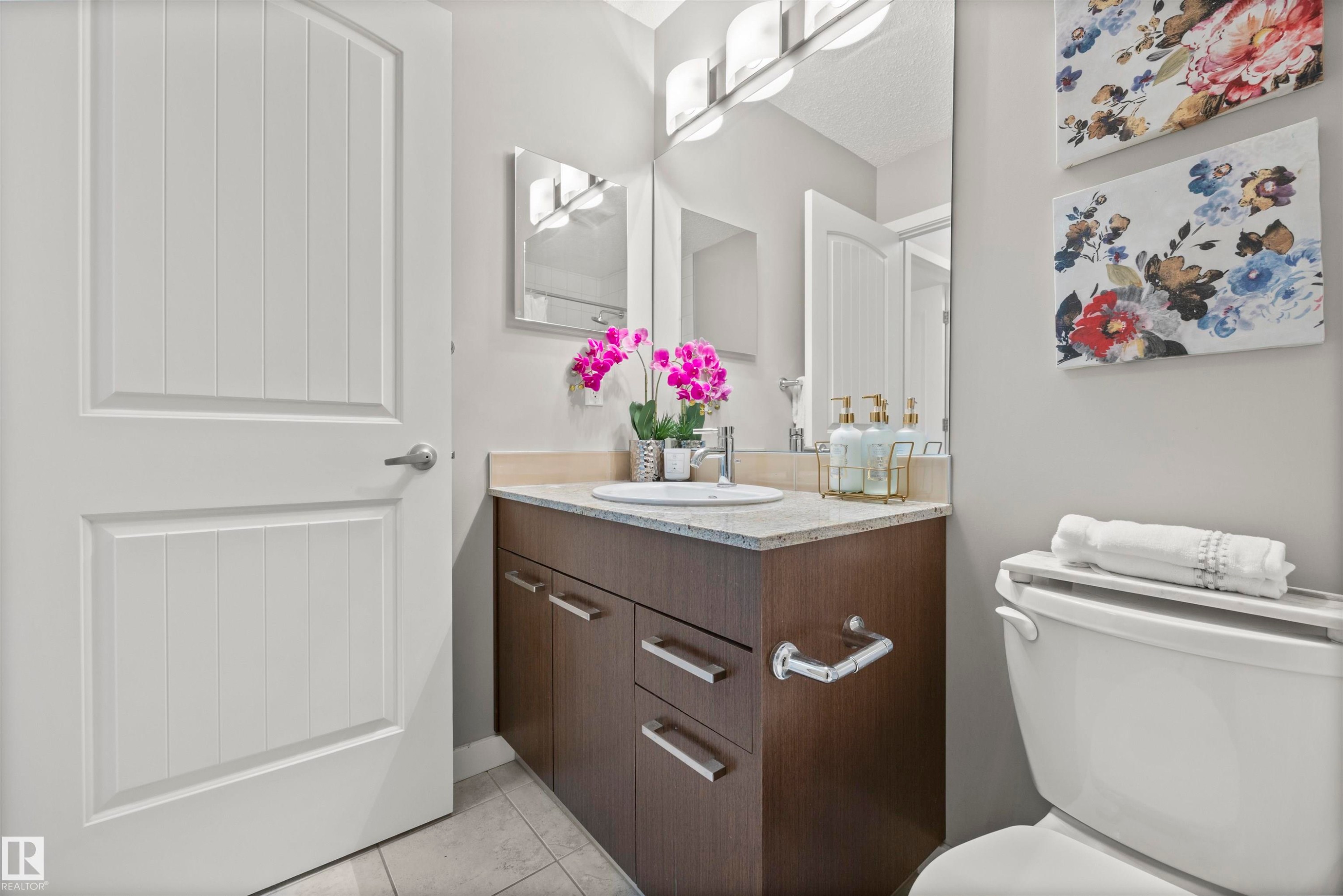 Bathroom with vanity and light tile patterned flooring - 56 655 Watt Boulevard, Edmonton, AB - Indoor Photo Showing Bathroom