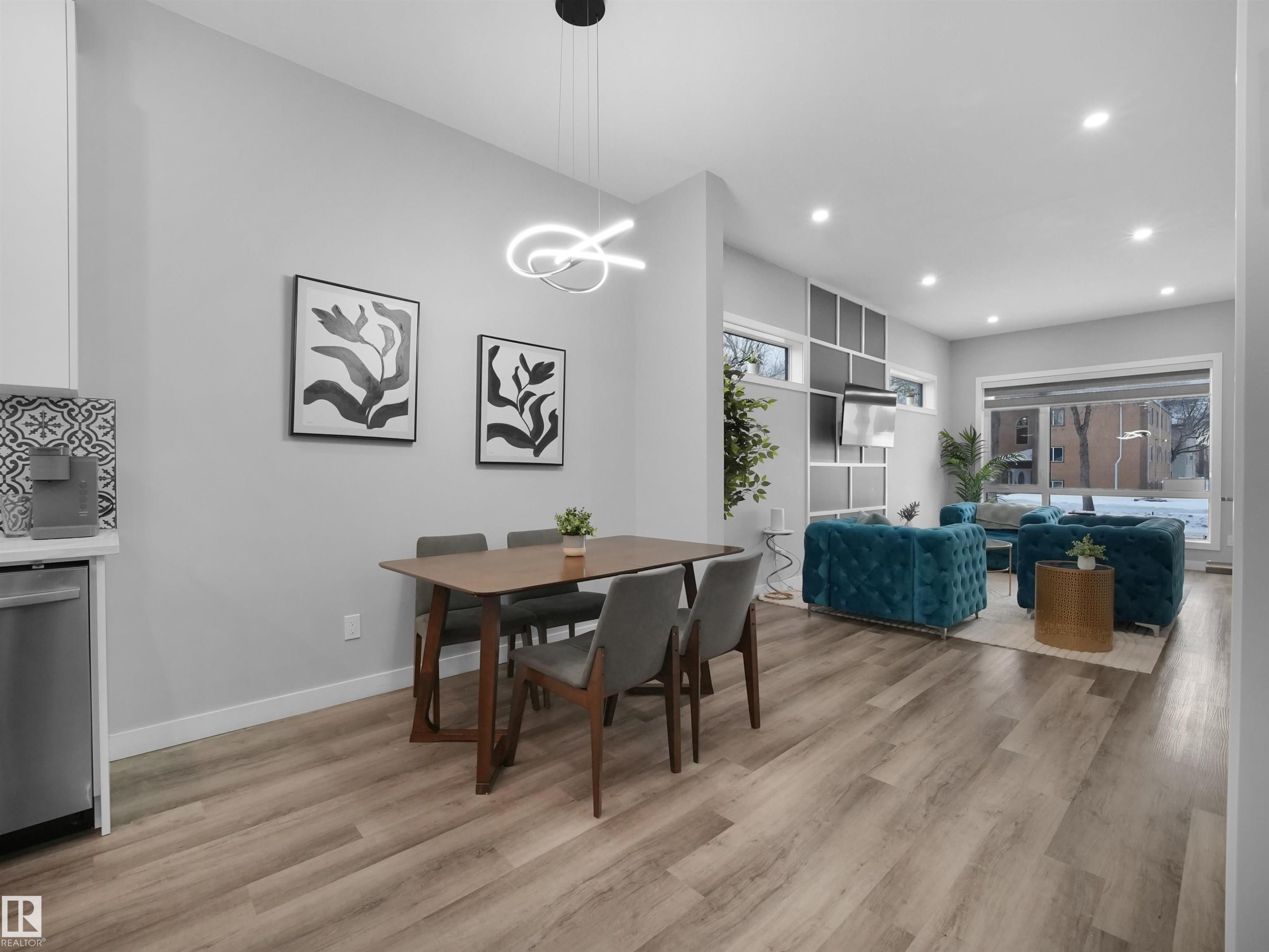 Dining room with light wood-style flooring, recessed lighting, and a chandelier - 10911 159 Street, Edmonton, AB - Indoor Photo Showing Dining Room