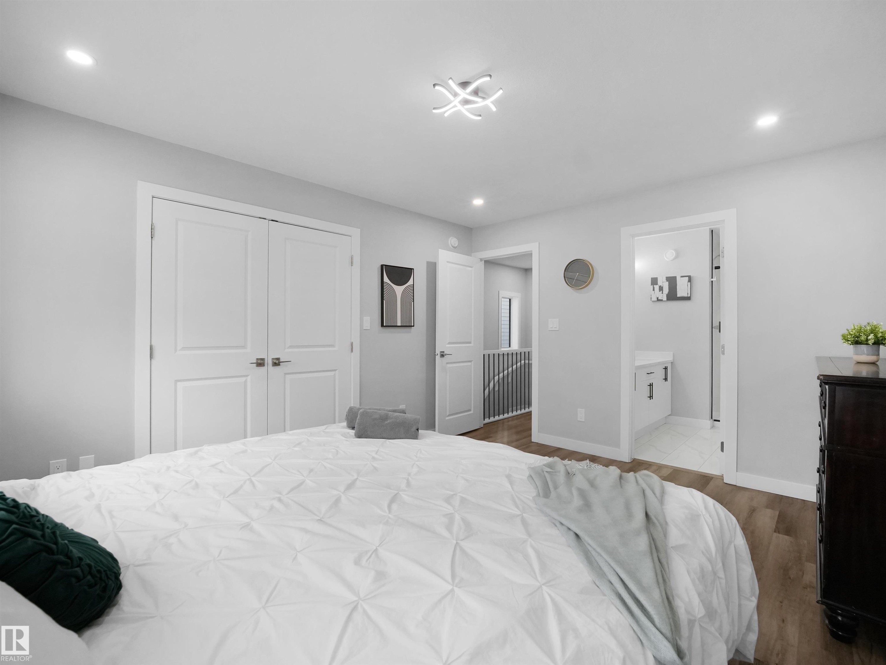 Bedroom with wood finished floors, recessed lighting, a closet, and ensuite bathroom - 10911 159 Street, Edmonton, AB - Indoor Photo Showing Bedroom
