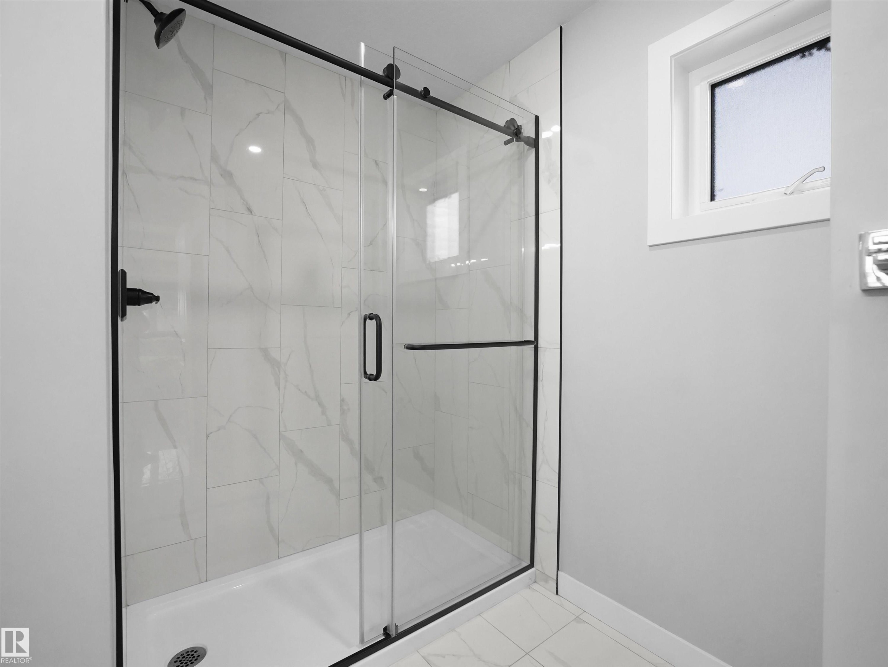 Full bathroom with a marble finish shower and marble look tile flooring - 10911 159 Street, Edmonton, AB - Indoor Photo Showing Bathroom