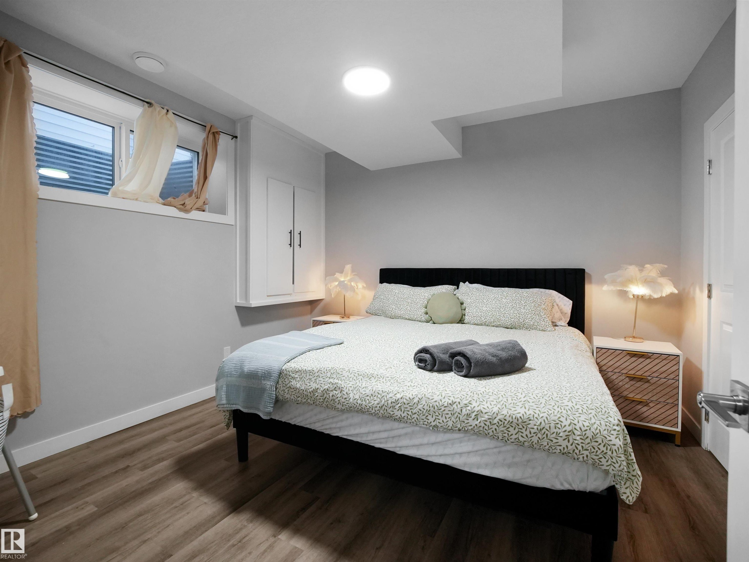 Bedroom with dark wood finished floors and baseboards - 10911 159 Street, Edmonton, AB - Indoor Photo Showing Bedroom
