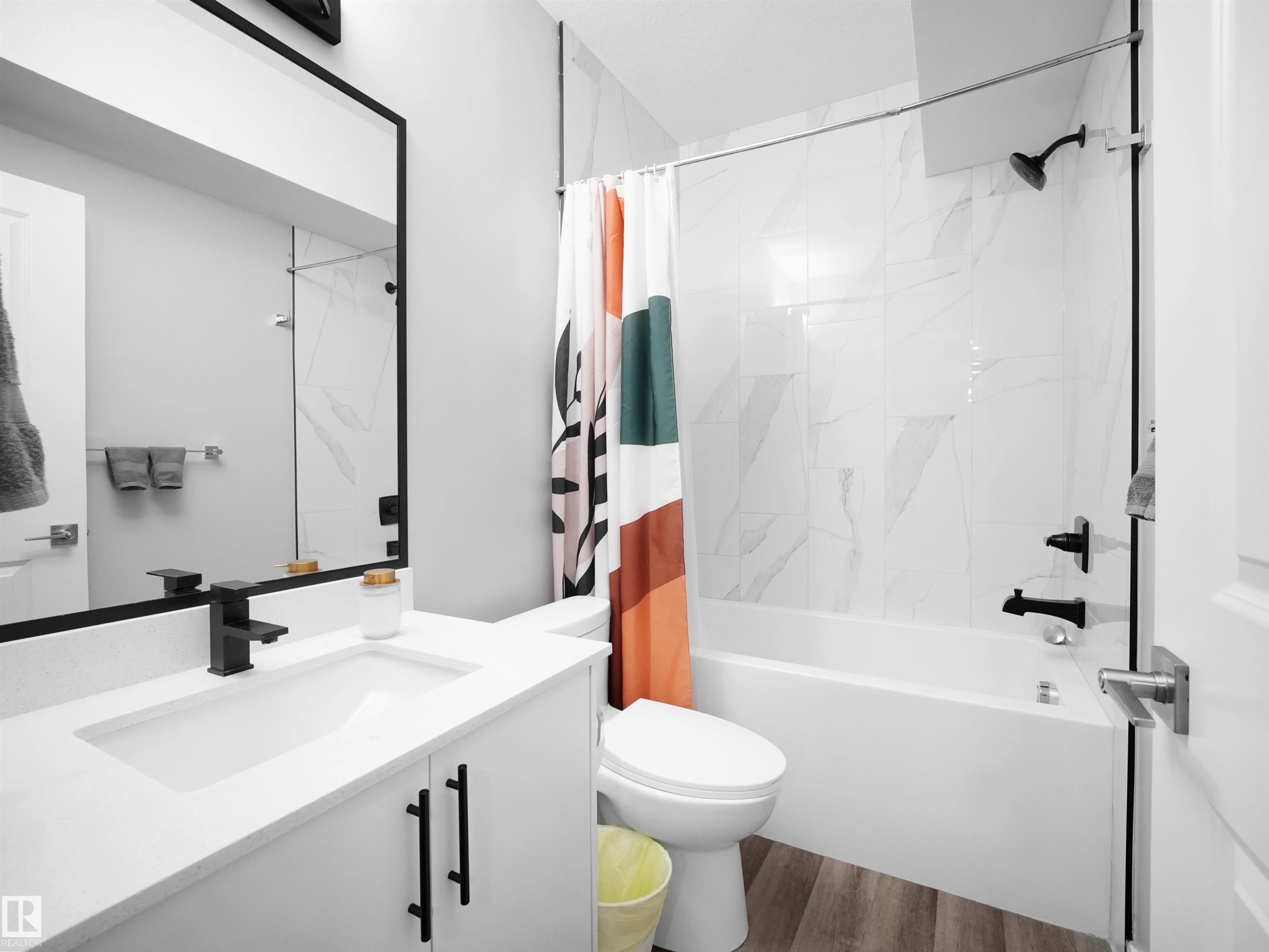 Full bathroom featuring vanity, shower / tub combo, and dark wood-style floors - 10911 159 Street, Edmonton, AB - Indoor Photo Showing Bathroom