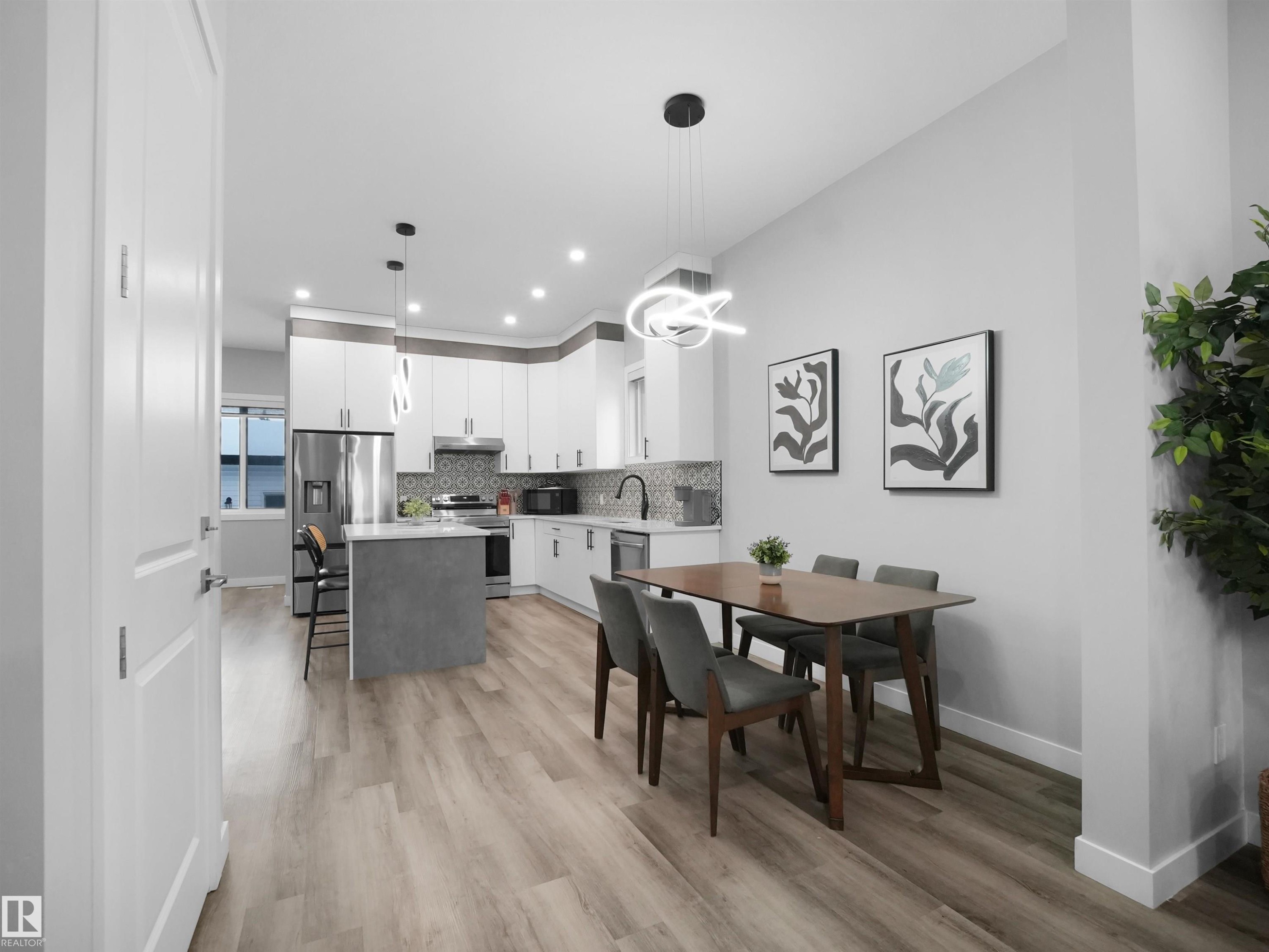 Dining room with light wood finished floors, recessed lighting, and a chandelier - 10911 159 Street, Edmonton, AB - Indoor Photo Showing Dining Room
