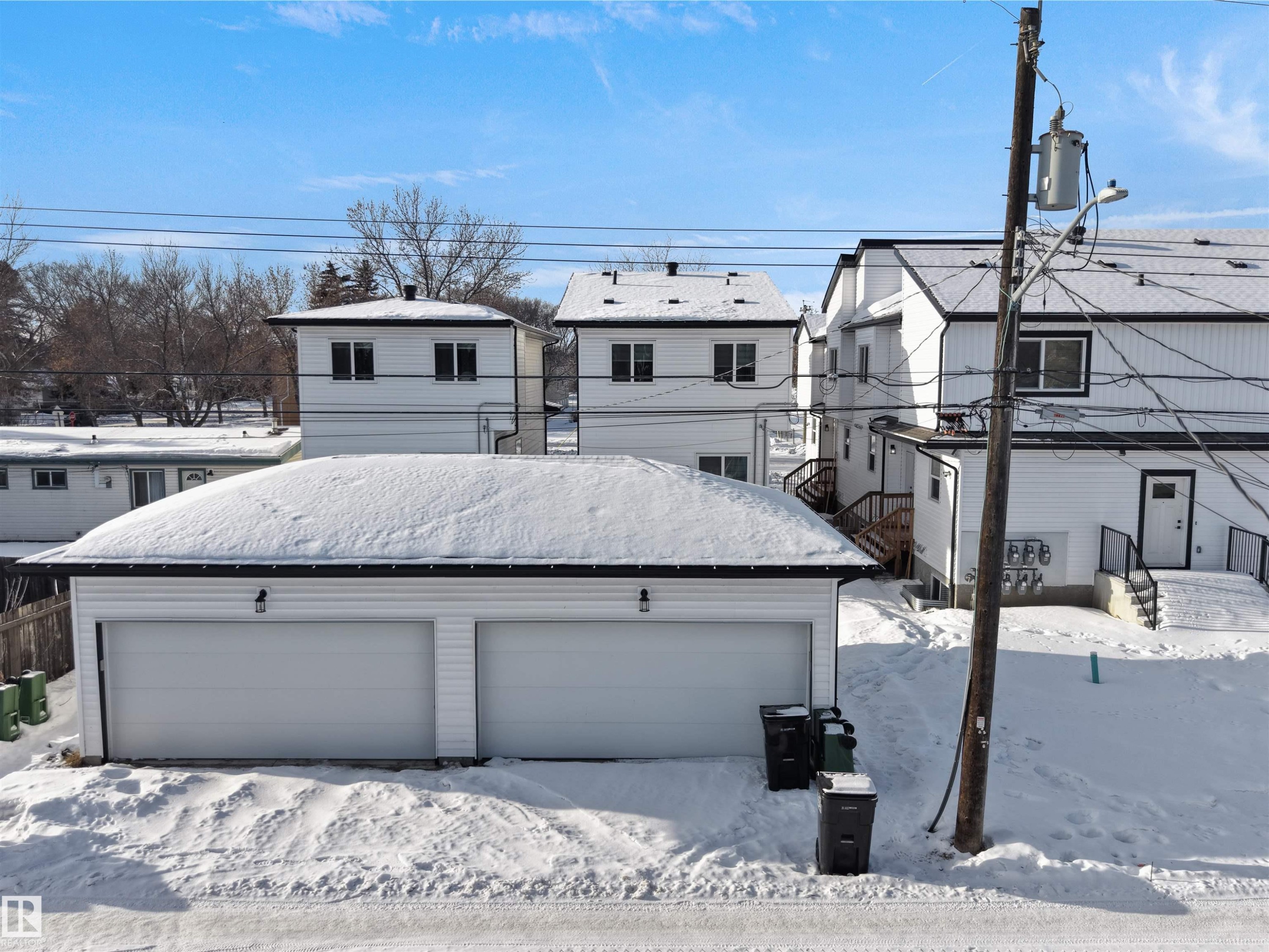 Snow covered property with an outdoor structure, a residential view, and a garage - 10913 159 Street, Edmonton, AB - Outdoor