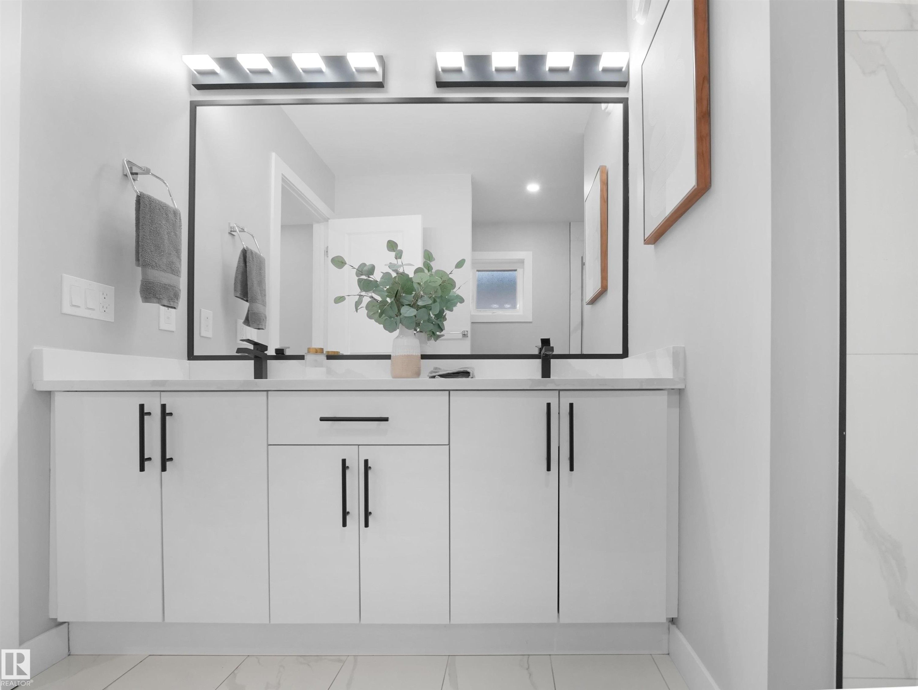 Bathroom featuring double vanity, recessed lighting, and light marble finish floors - 10913 159 Street, Edmonton, AB - Indoor Photo Showing Bathroom