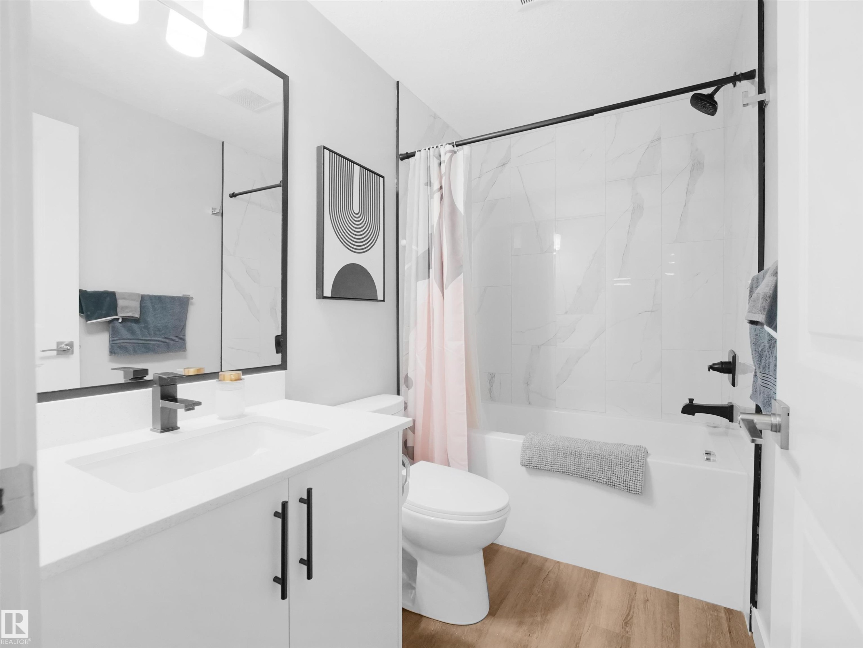 Legal basement suite Full bathroom with shower / tub combo, vanity, and light wood finished floors - 10913 159 Street, Edmonton, AB - Indoor Photo Showing Bathroom