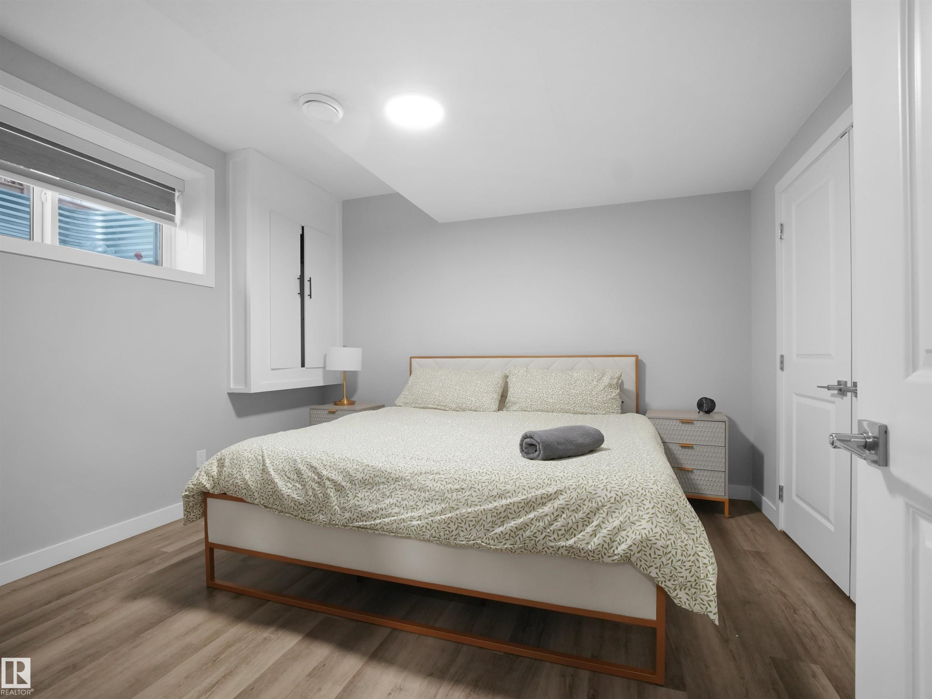 Legal basement suite Bedroom with wood finished floors and baseboards - 10913 159 Street, Edmonton, AB - Indoor Photo Showing Bedroom
