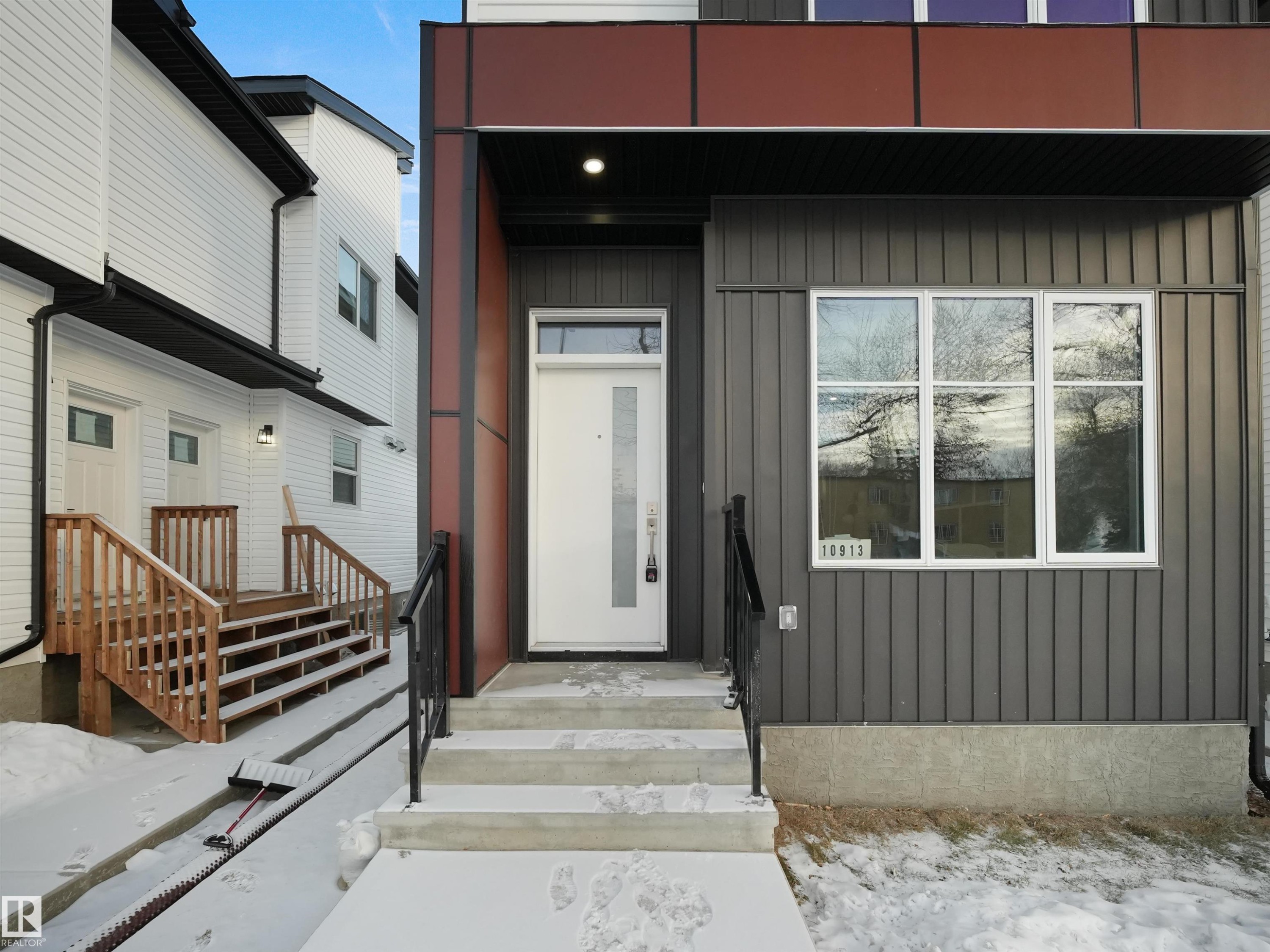 Snow covered property entrance featuring board and batten siding - 10913 159 Street, Edmonton, AB - Outdoor With Exterior