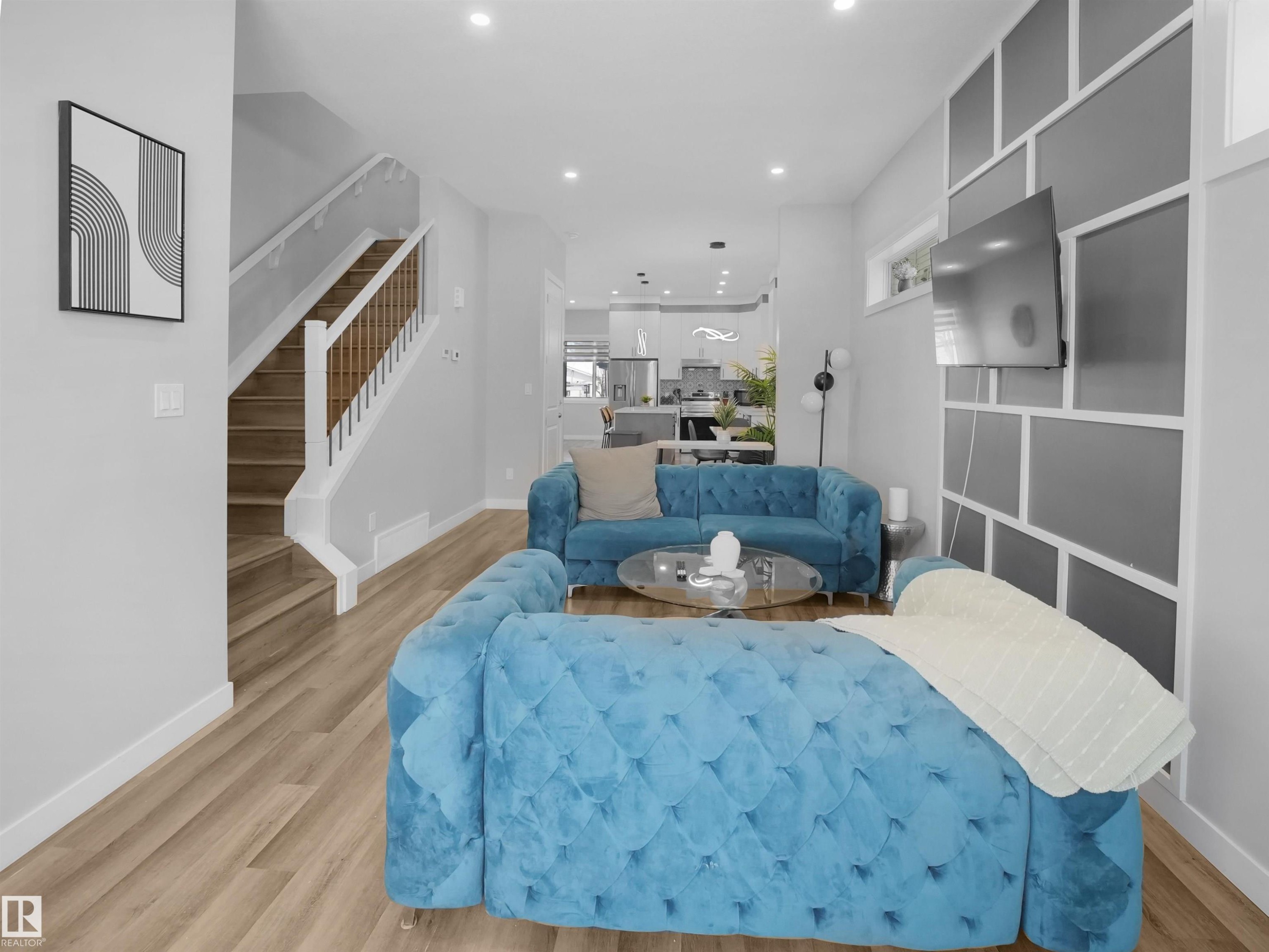 Living area featuring light wood-type flooring, stairway, and recessed lighting - 10913 159 Street, Edmonton, AB - Indoor