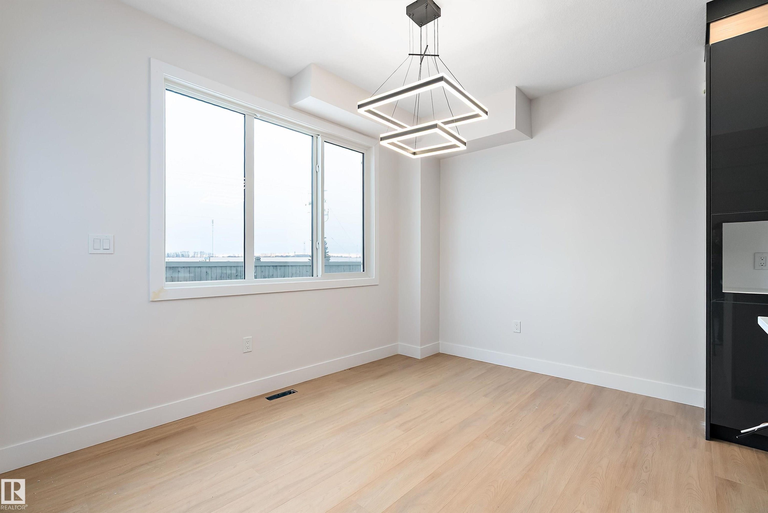 Unfurnished dining area with light wood-style flooring and a chandelier - 38 Astoria Place, Devon, AB - Indoor Photo Showing Other Room