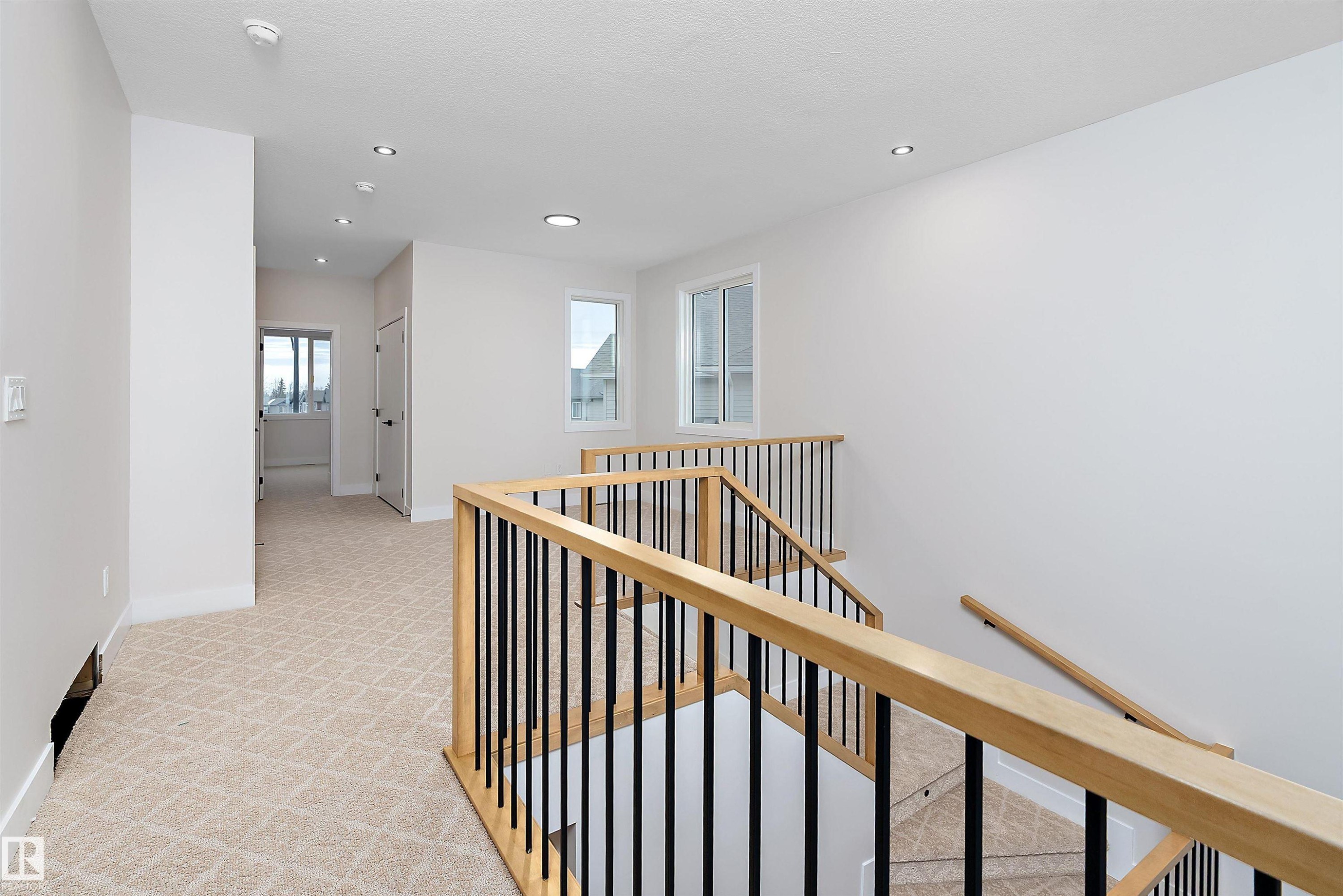 Corridor featuring an upstairs landing, light carpet, and recessed lighting - 38 Astoria Place, Devon, AB - Indoor Photo Showing Other Room