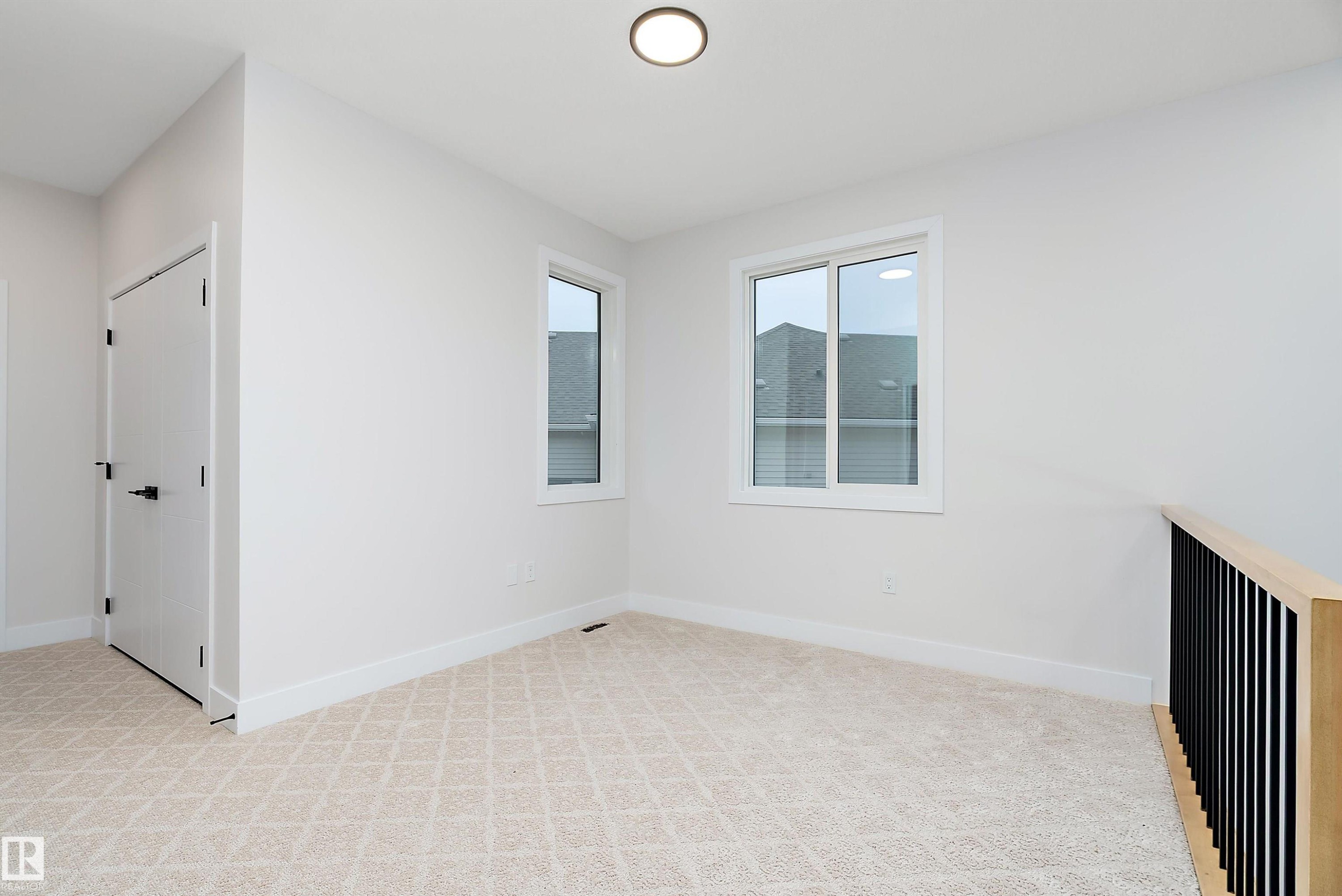 Spare room with light carpet and baseboards - 38 Astoria Place, Devon, AB - Indoor Photo Showing Other Room