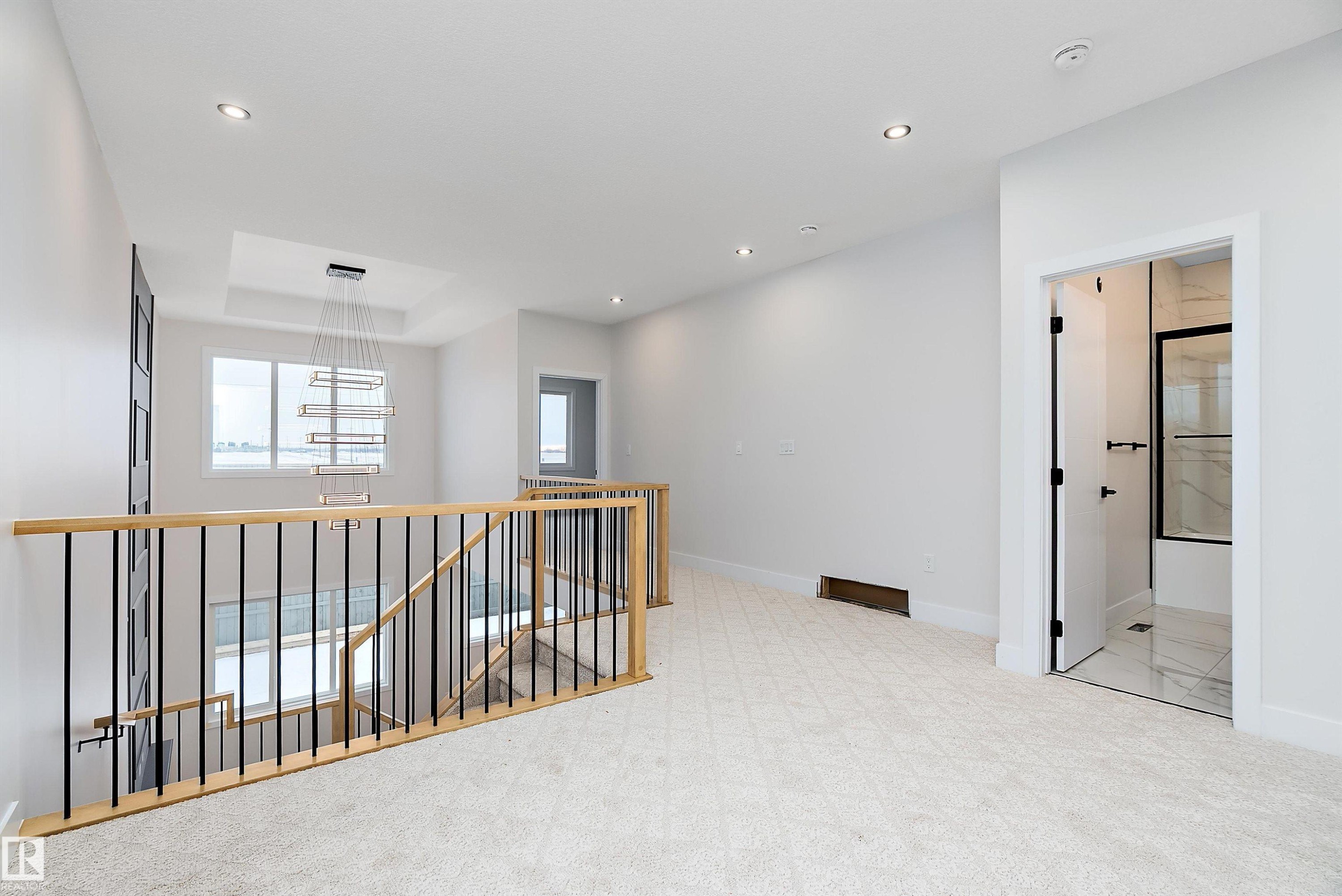 Corridor with an upstairs landing, light carpet, and recessed lighting - 38 Astoria Place, Devon, AB - Indoor Photo Showing Other Room