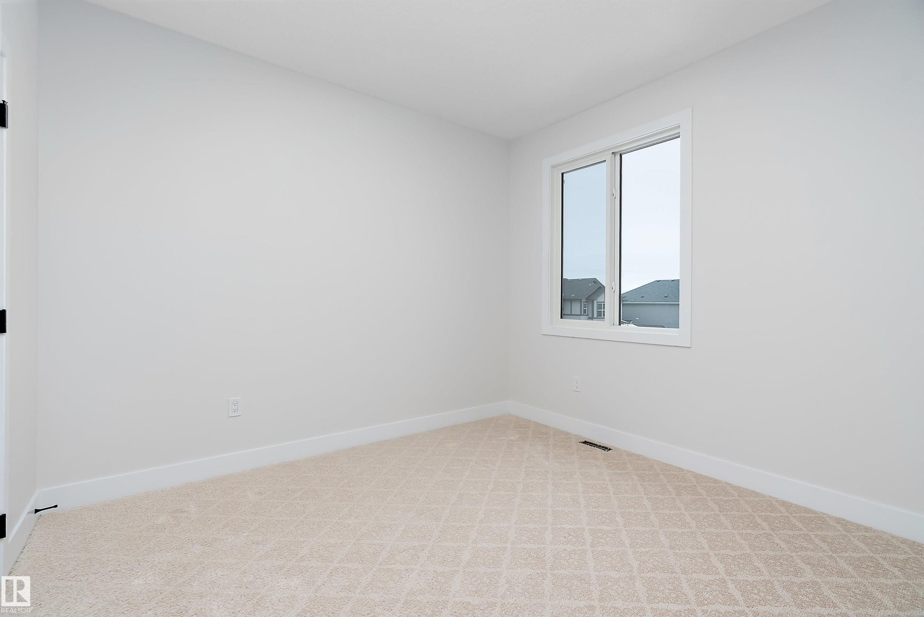 Empty room featuring baseboards and light colored carpet - 38 Astoria Place, Devon, AB - Indoor Photo Showing Other Room