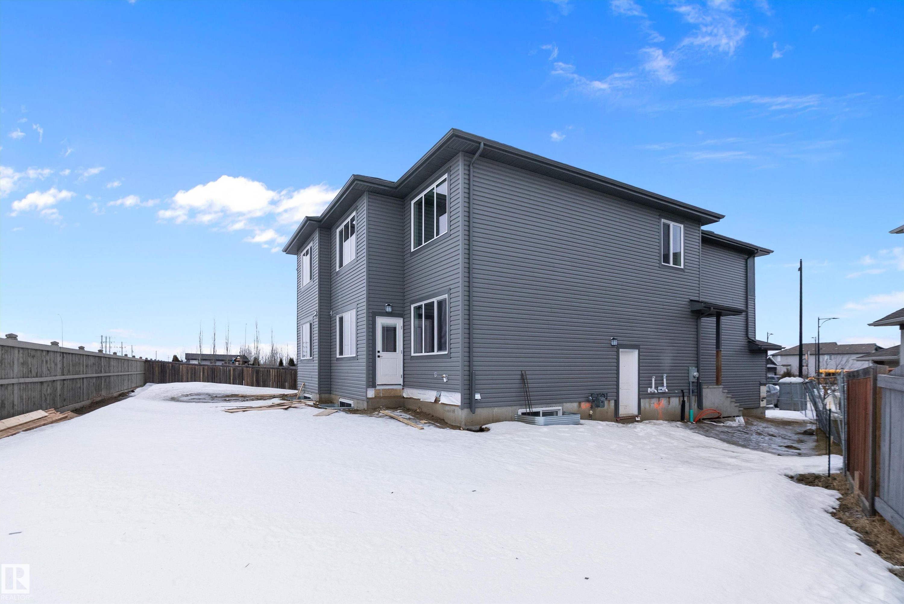 Snow covered property featuring a fenced backyard - 38 Astoria Place, Devon, AB - Outdoor