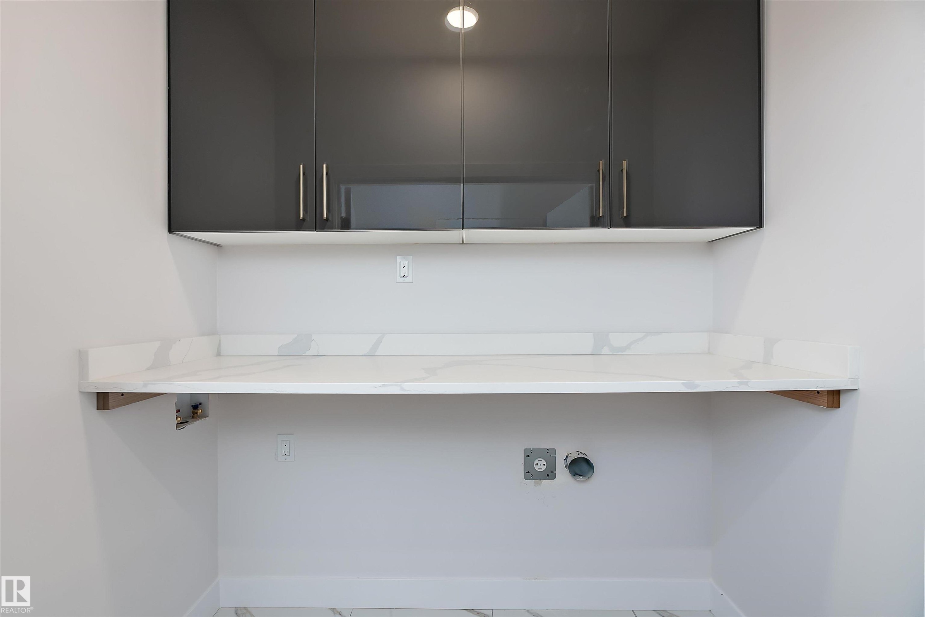 Washroom with cabinet space and hookup for a washing machine - 38 Astoria Place, Devon, AB - Indoor