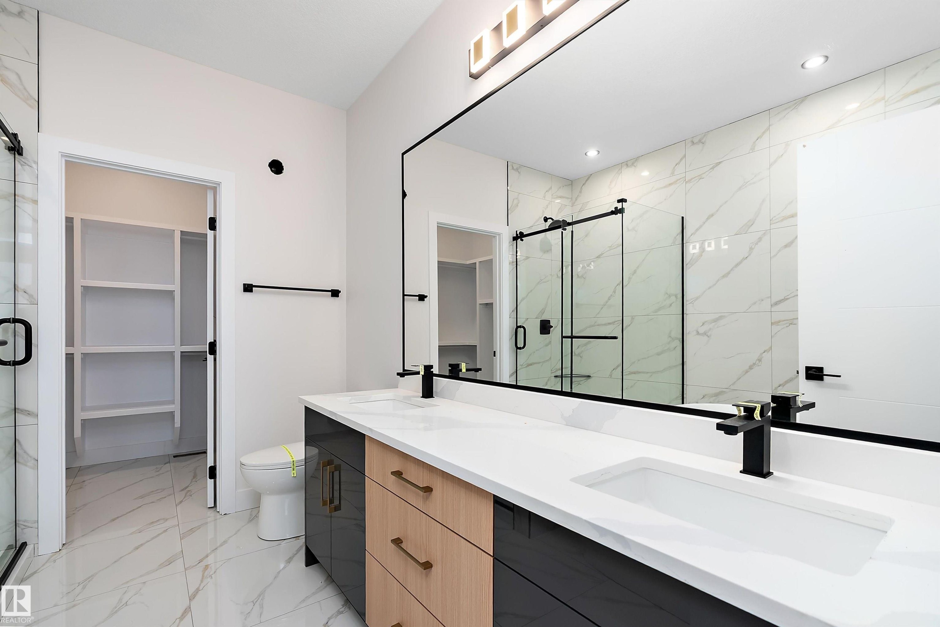 Bathroom with a spacious closet, light marble finish flooring, and a marble finish shower - 38 Astoria Place, Devon, AB - Indoor Photo Showing Bathroom