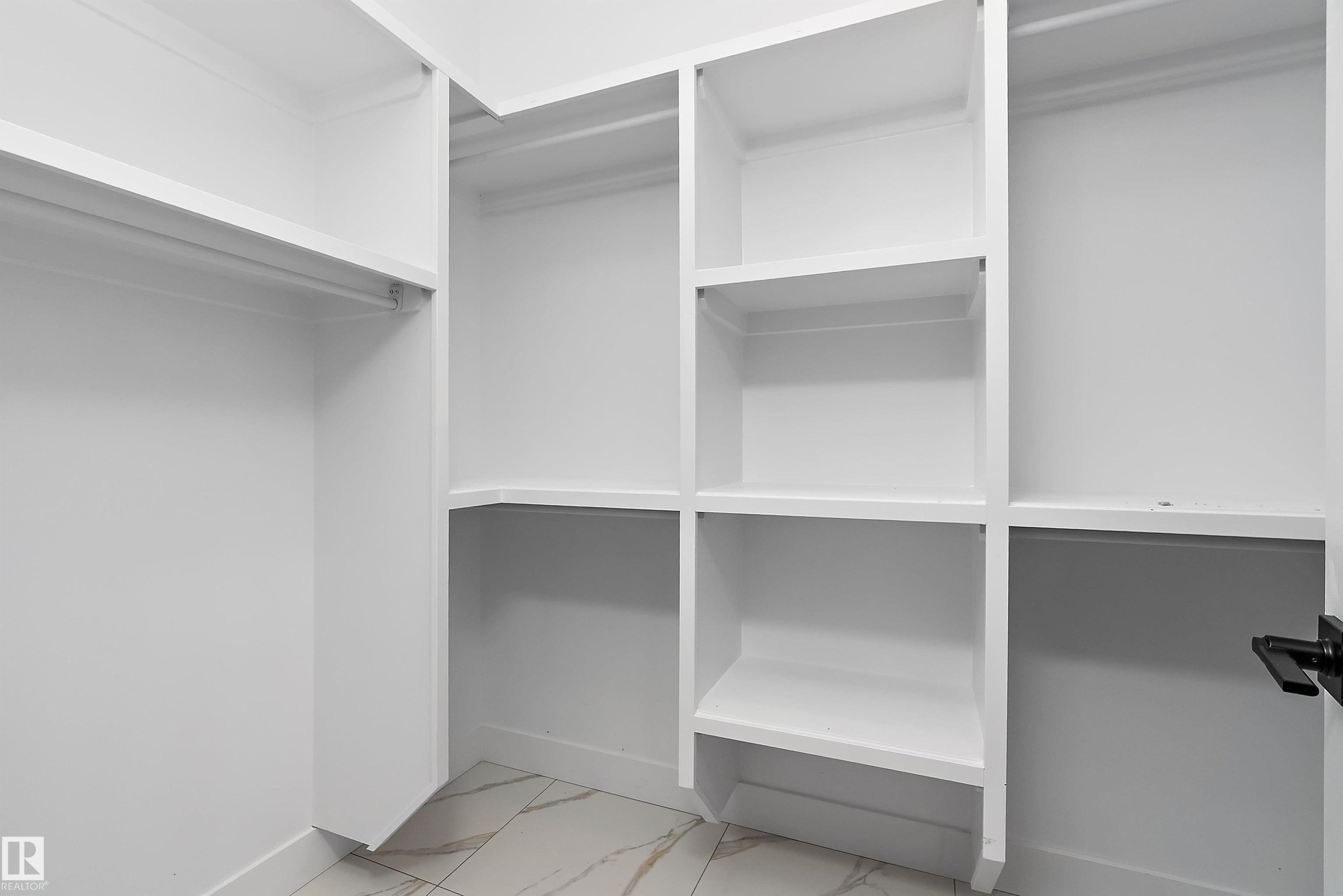 Spacious closet with light marble finish floors - 38 Astoria Place, Devon, AB - Indoor With Storage