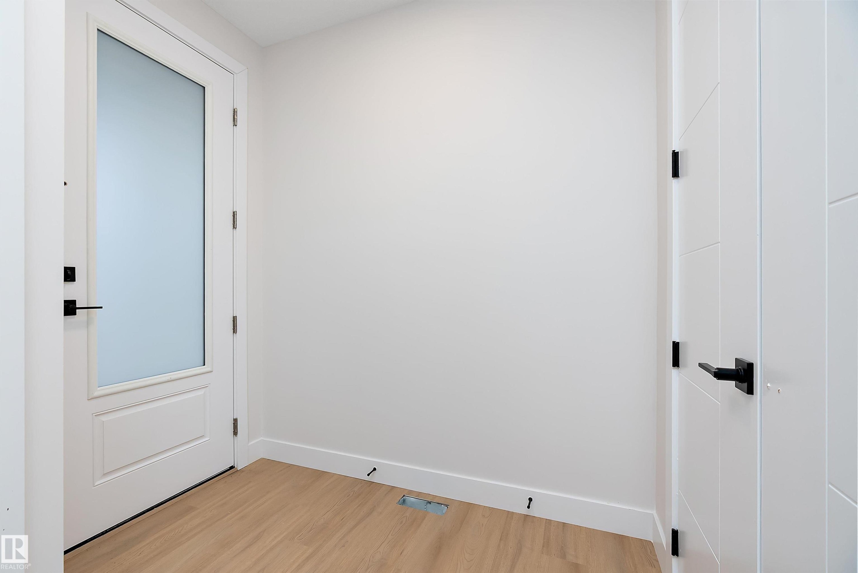 Empty room with baseboards and light wood-style flooring - 38 Astoria Place, Devon, AB - Indoor Photo Showing Other Room