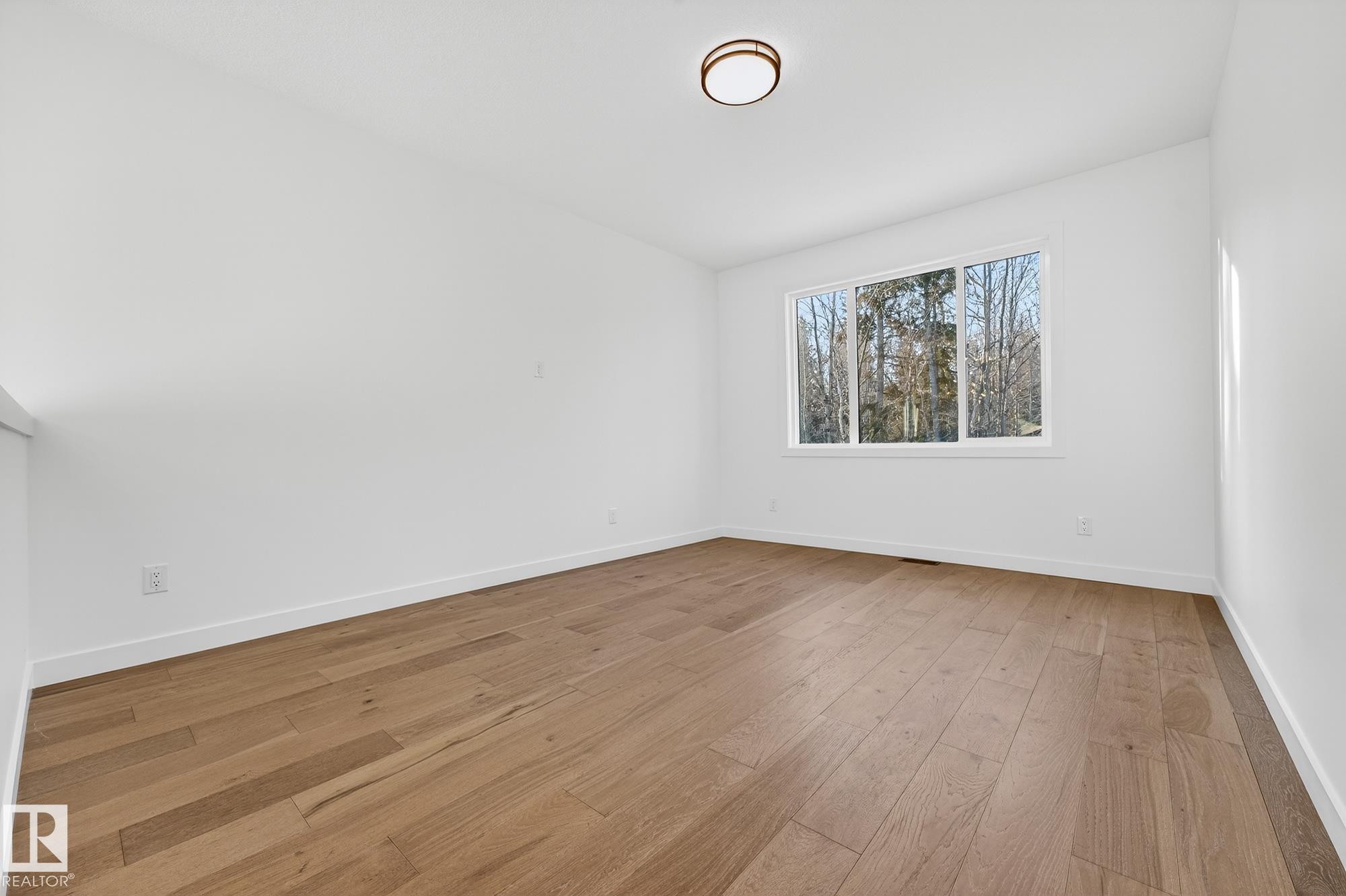 Unfurnished room with light wood finished floors and baseboards - 132 Heron Point Close, Rural Wetaskiwin County, AB - Indoor Photo Showing Other Room