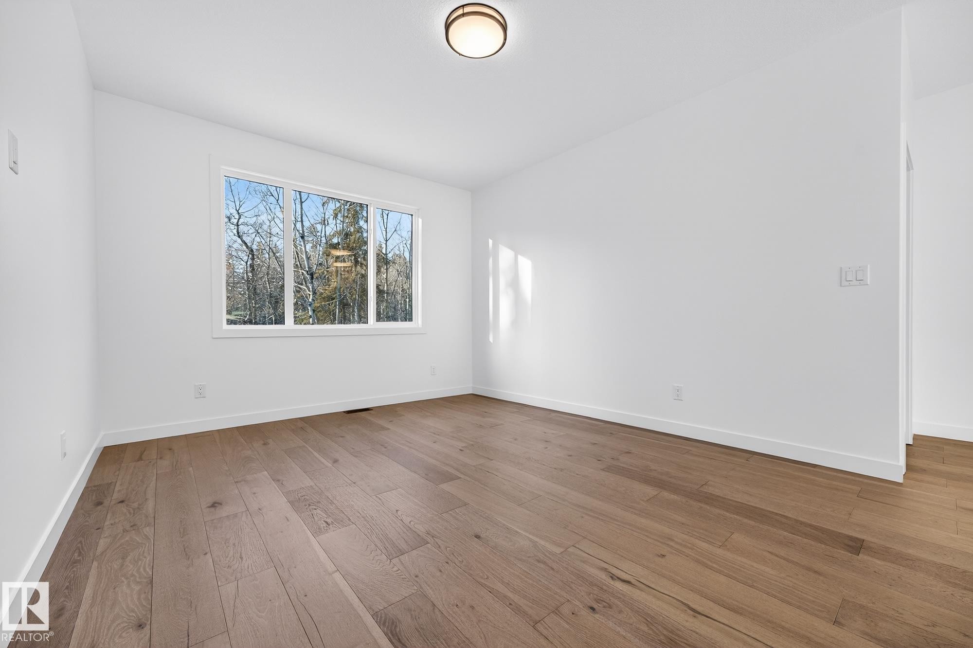 Spare room with baseboards and light wood finished floors - 132 Heron Point Close, Rural Wetaskiwin County, AB - Indoor Photo Showing Other Room