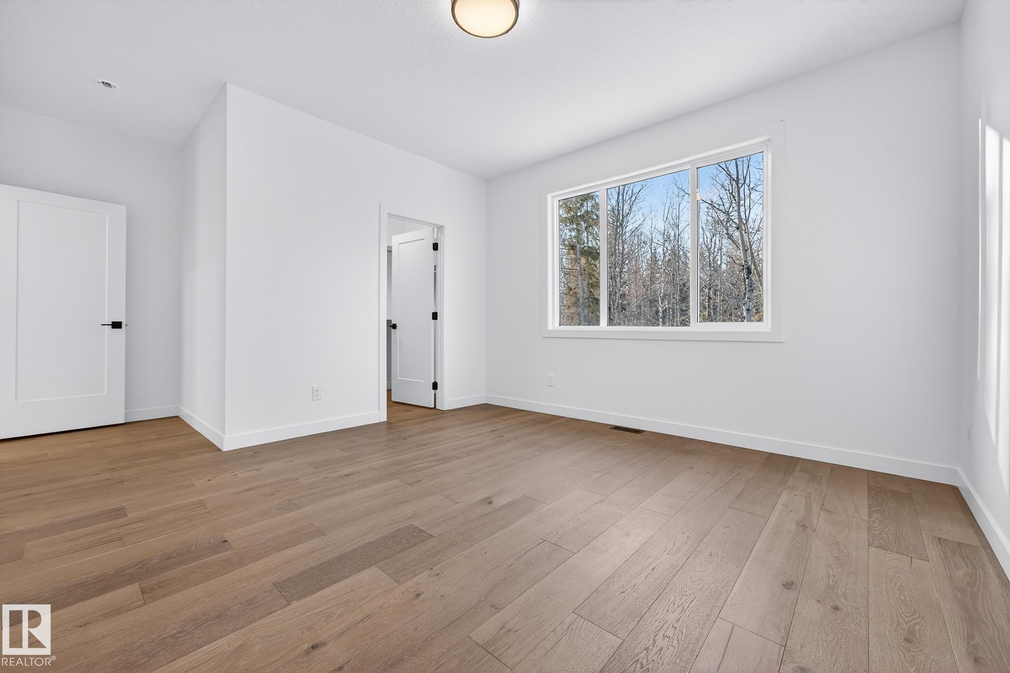 Unfurnished bedroom featuring light wood-style floors - 132 Heron Point Close, Rural Wetaskiwin County, AB - Indoor Photo Showing Other Room