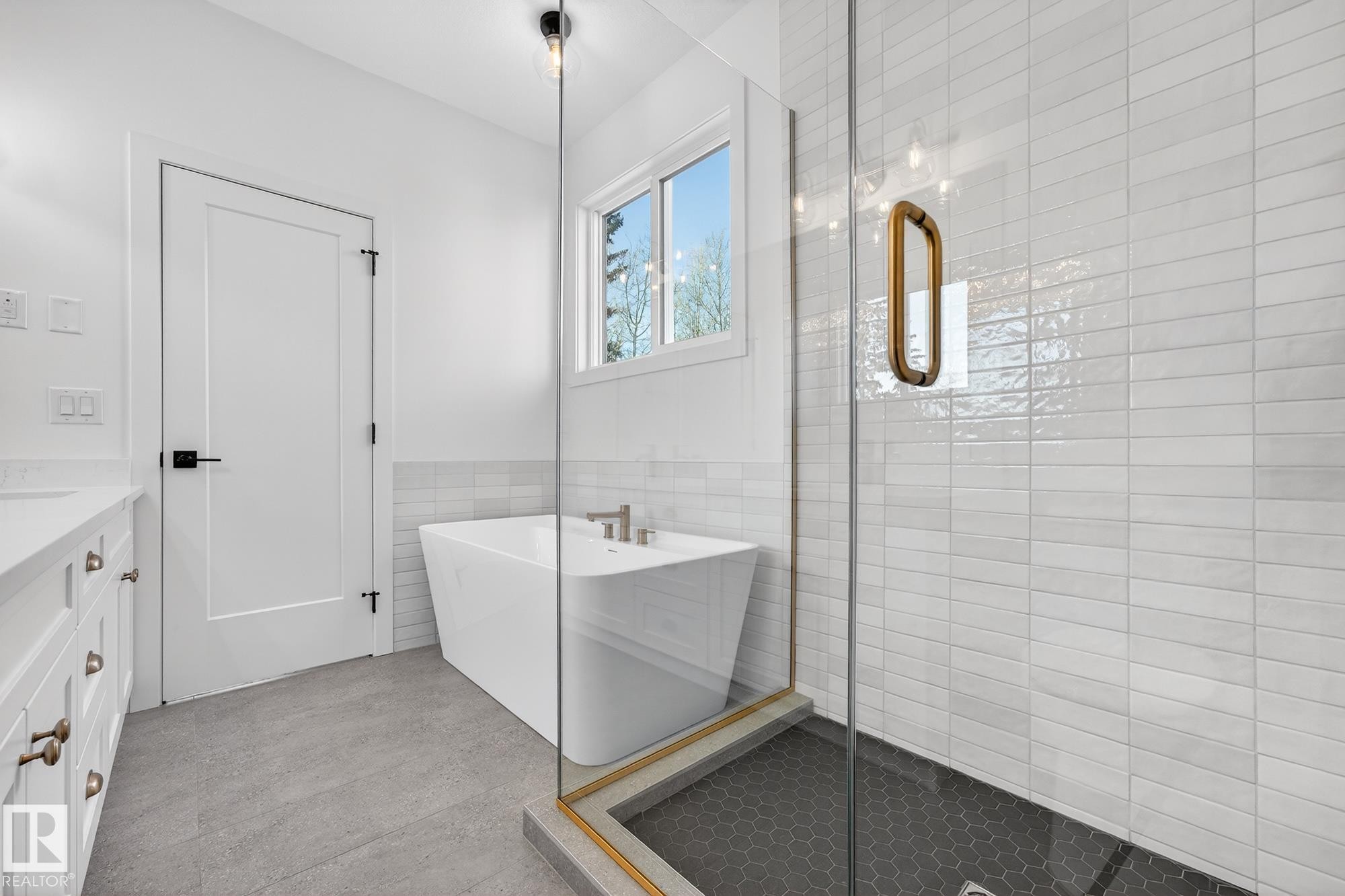 Full bathroom with tile walls, a stall shower, a freestanding tub, vanity, and wainscoting - 132 Heron Point Close, Rural Wetaskiwin County, AB - Indoor Photo Showing Bathroom