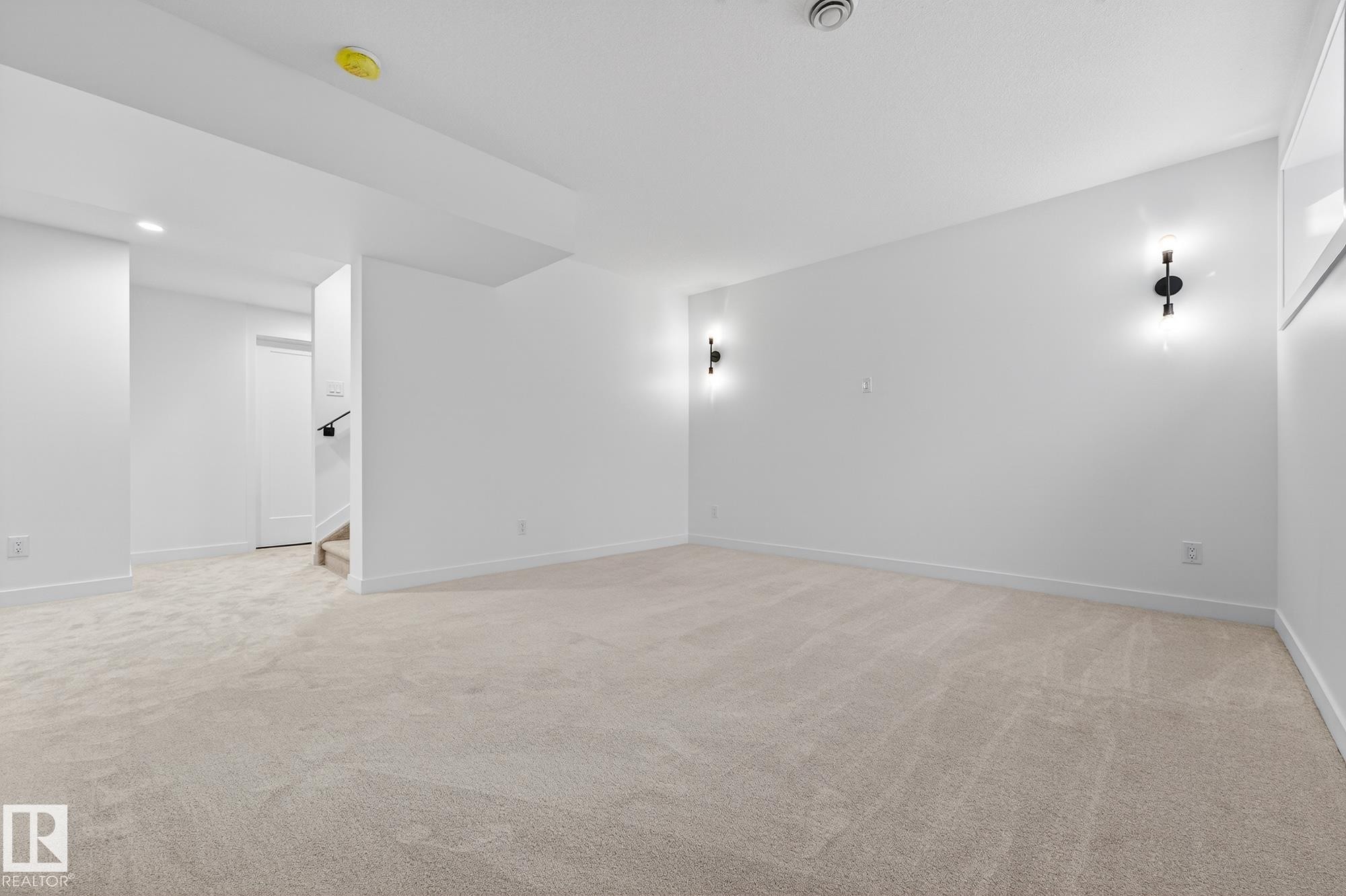Spare room featuring light colored carpet, stairs, and recessed lighting - 132 Heron Point Close, Rural Wetaskiwin County, AB - Indoor Photo Showing Other Room