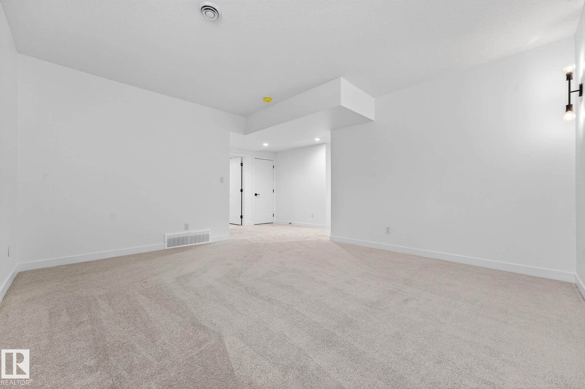 Unfurnished room featuring light carpet and recessed lighting - 132 Heron Point Close, Rural Wetaskiwin County, AB - Indoor Photo Showing Other Room