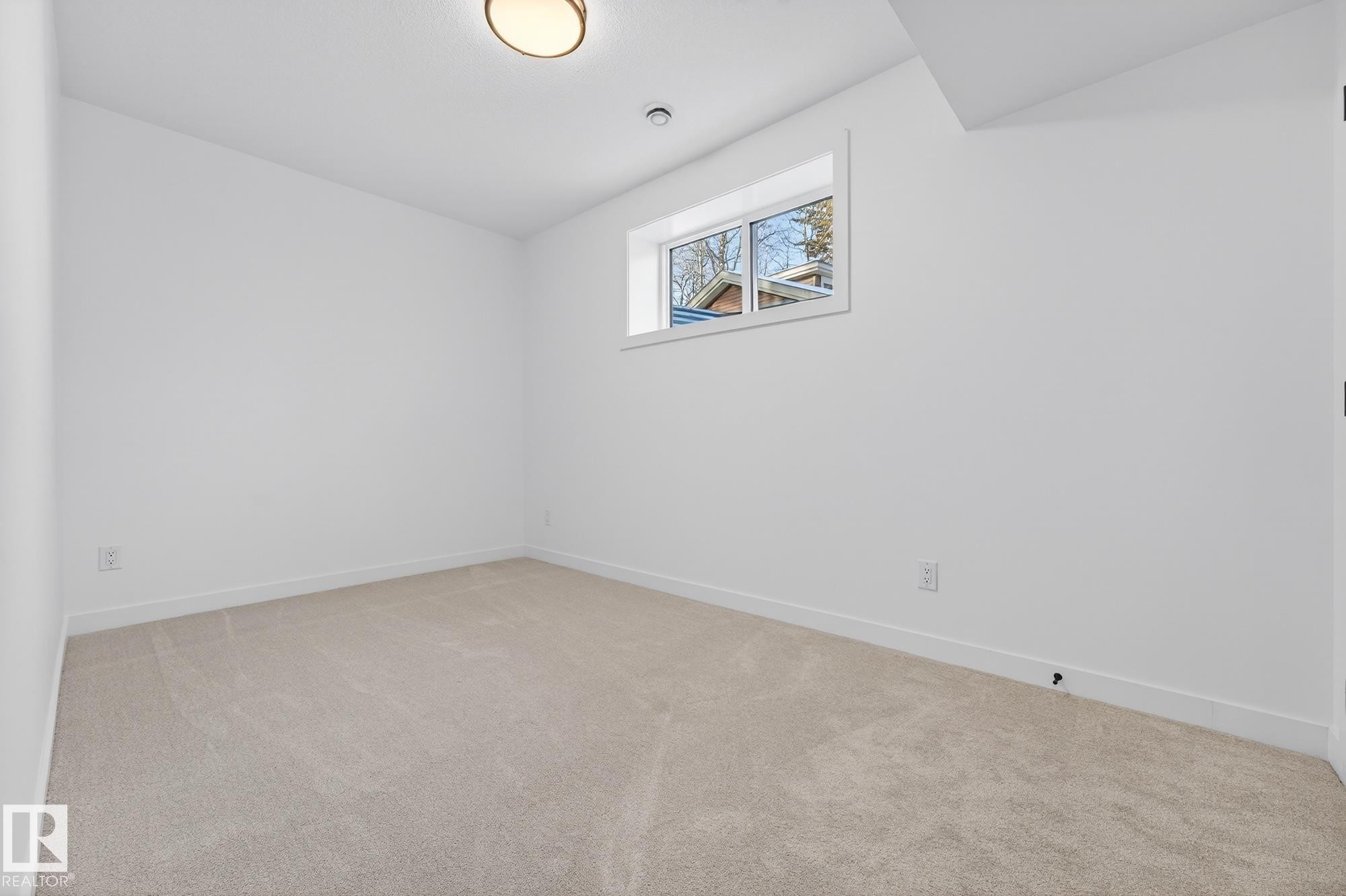 Empty room with light carpet and baseboards - 132 Heron Point Close, Rural Wetaskiwin County, AB - Indoor Photo Showing Other Room