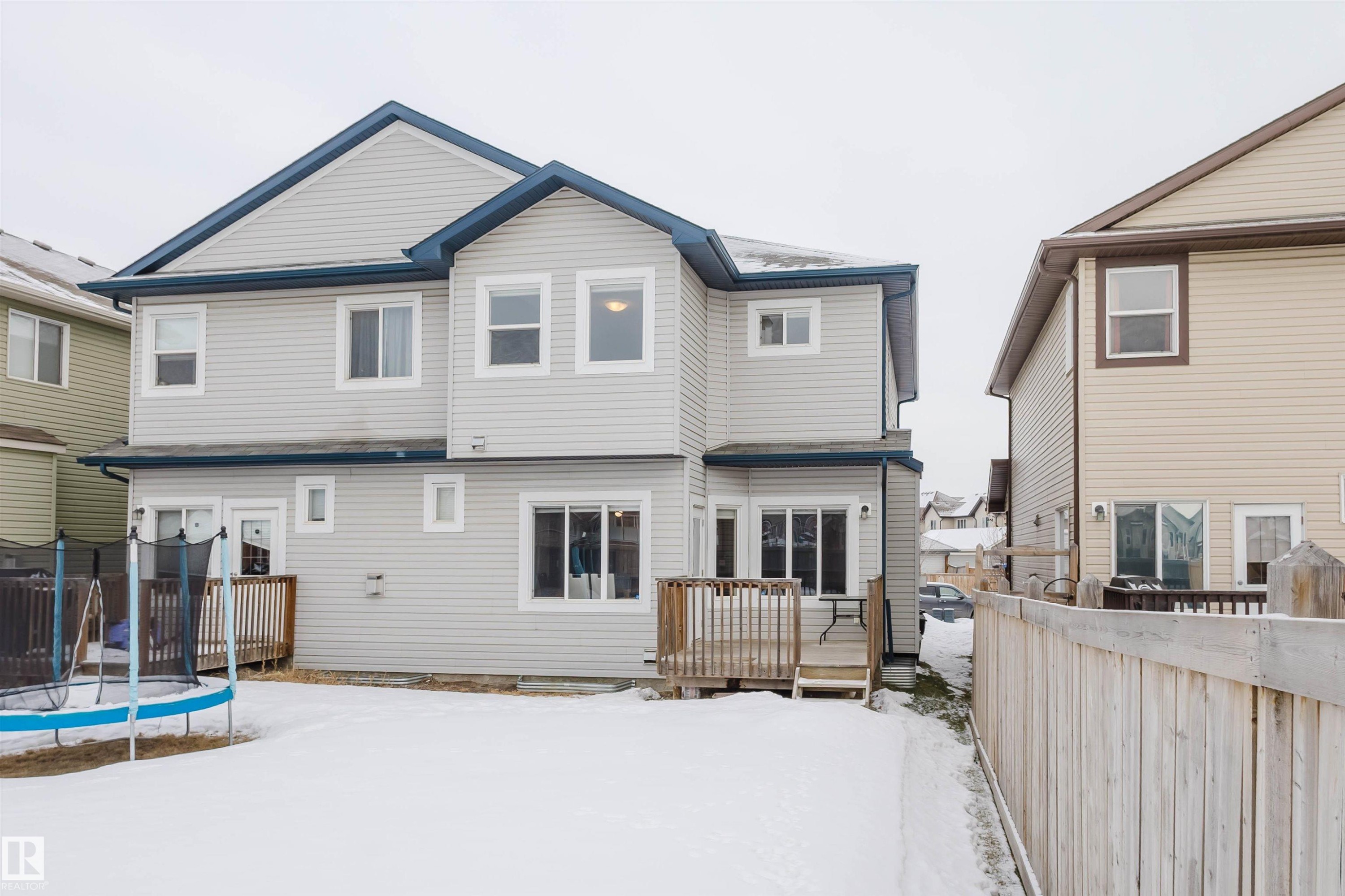 Snow covered property featuring a deck and a trampoline - 3921 167A Avenue, Edmonton, AB - Outdoor