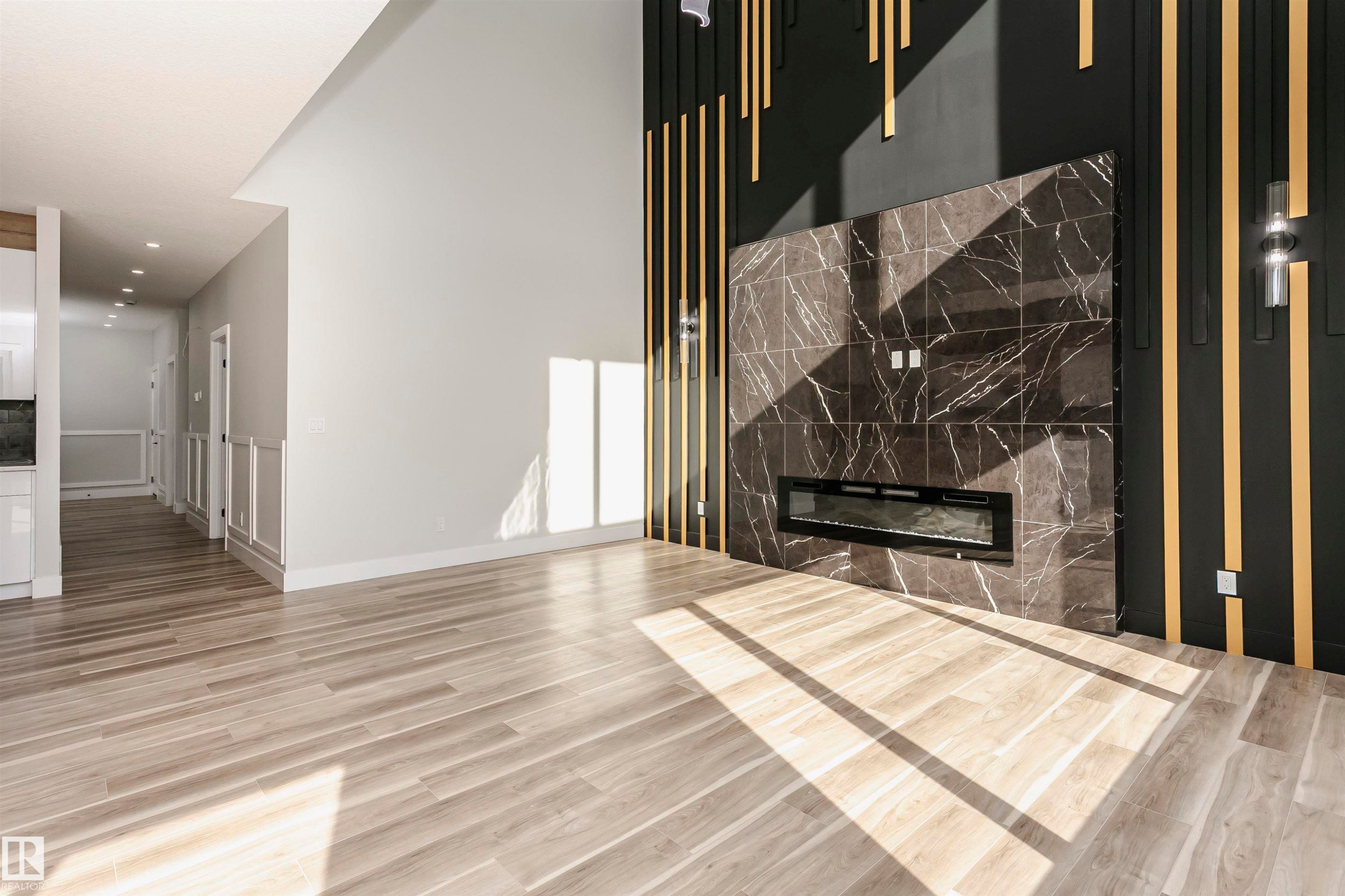 Unfurnished living room with LVP finished floors, a premium fireplace, and recessed lighting - 1723 19 Street, Edmonton, AB - Indoor With Fireplace