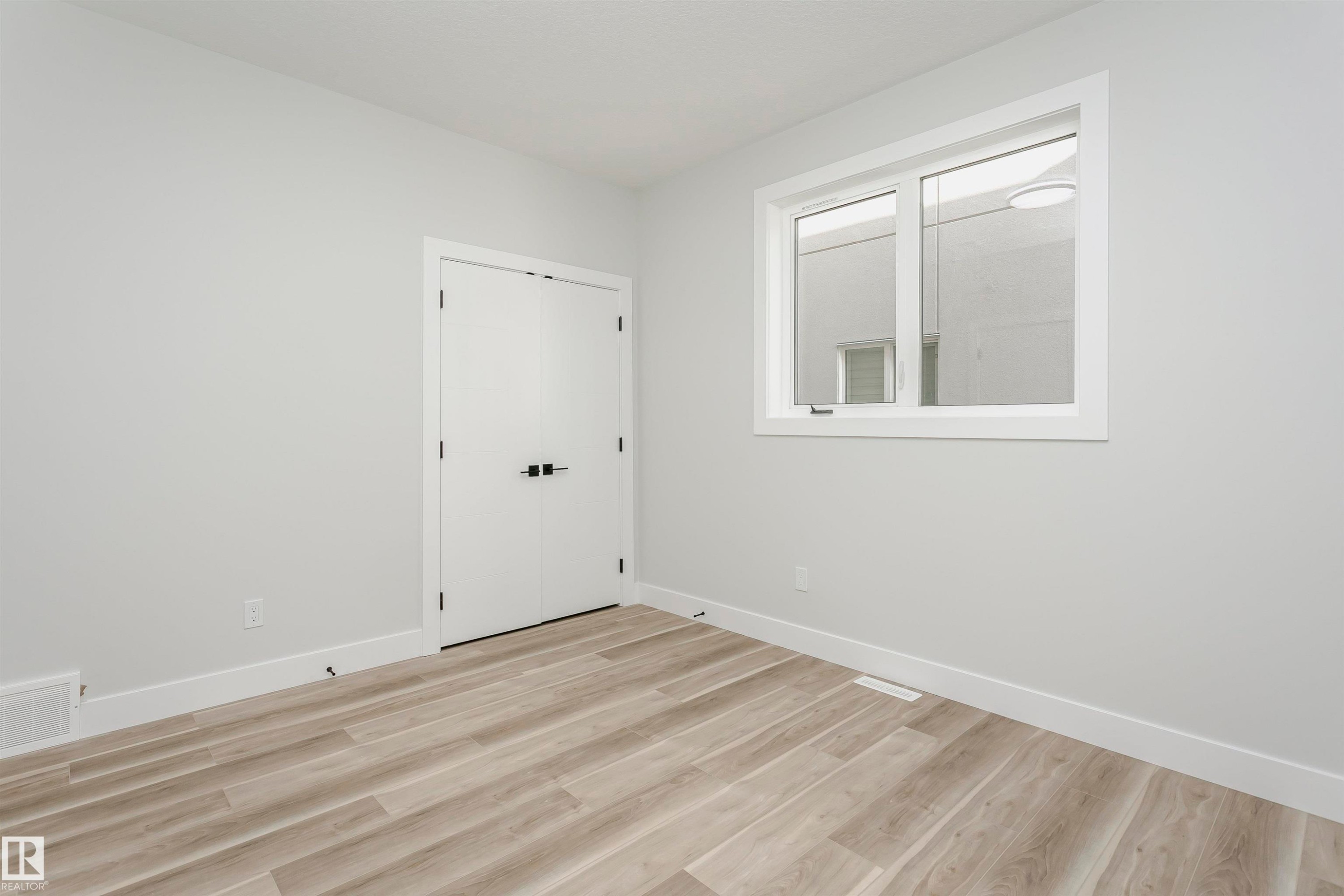 Bedroom featuring light wood-style flooring - 1723 19 Street, Edmonton, AB - Indoor Photo Showing Other Room