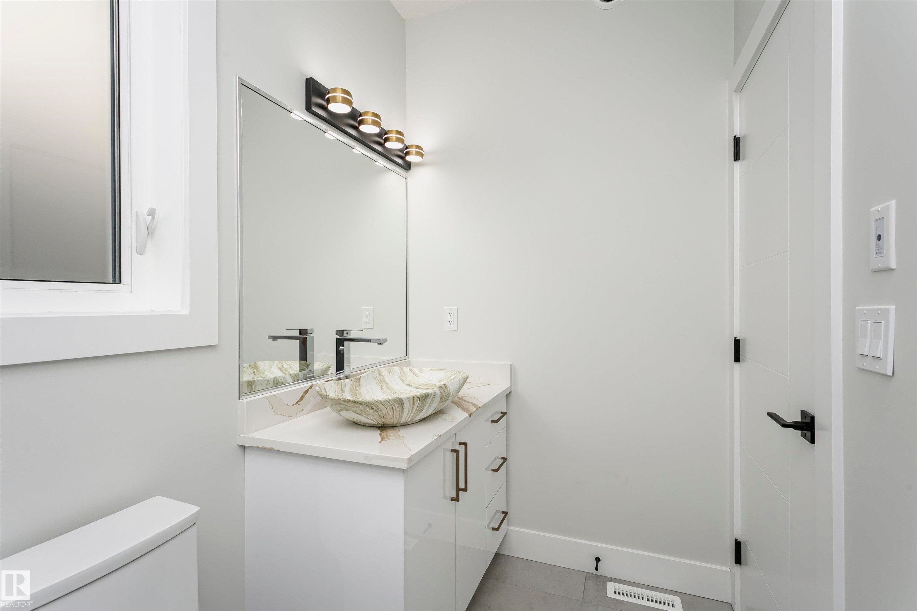 Bathroom featuring vanity and light tile patterned flooring - 1723 19 Street, Edmonton, AB - Indoor Photo Showing Other Room