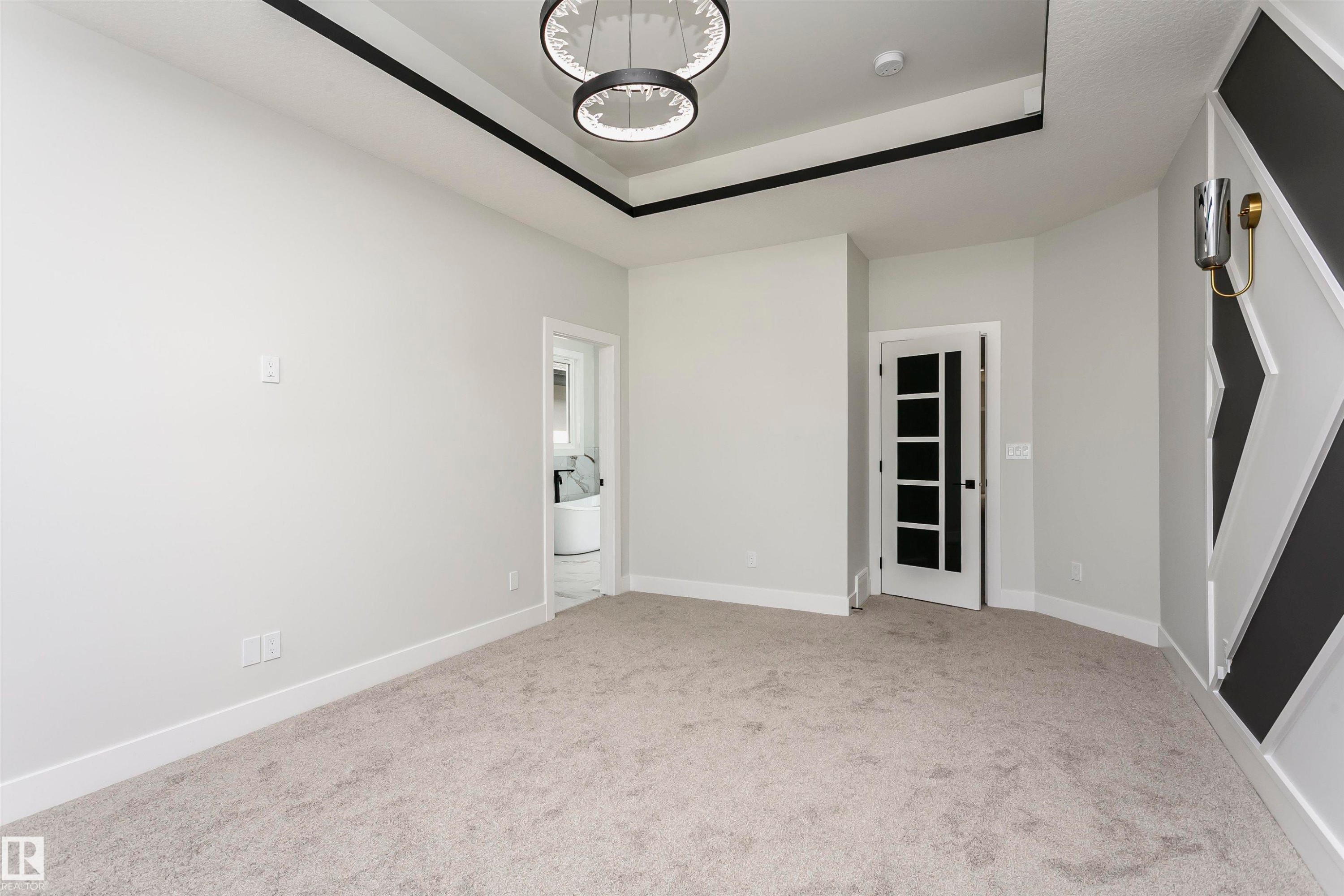 Unfurnished room featuring light carpet and a tray ceiling - 1723 19 Street, Edmonton, AB - Indoor Photo Showing Other Room