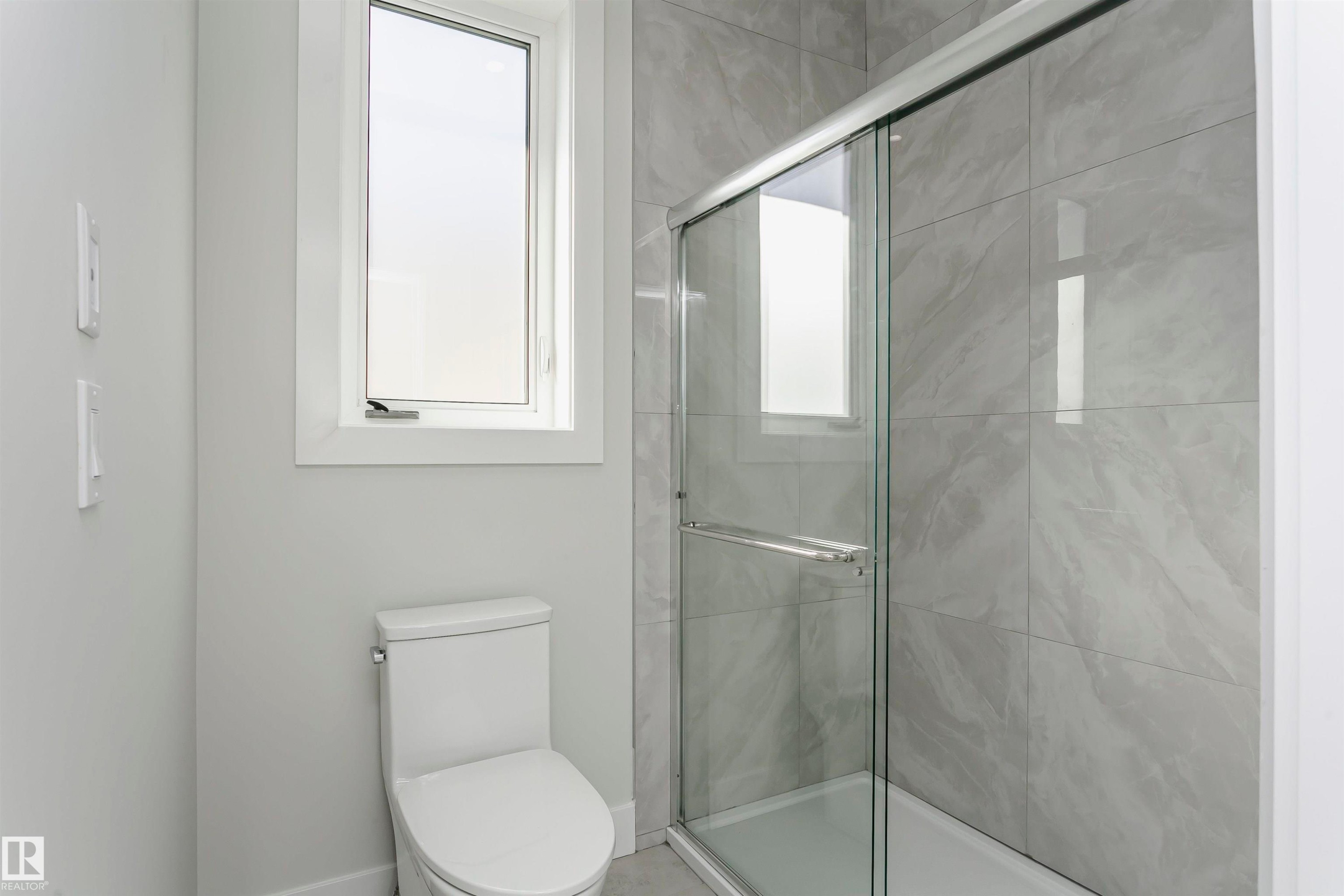 Full bath featuring a shower stall and toilet - 1723 19 Street, Edmonton, AB - Indoor Photo Showing Bathroom