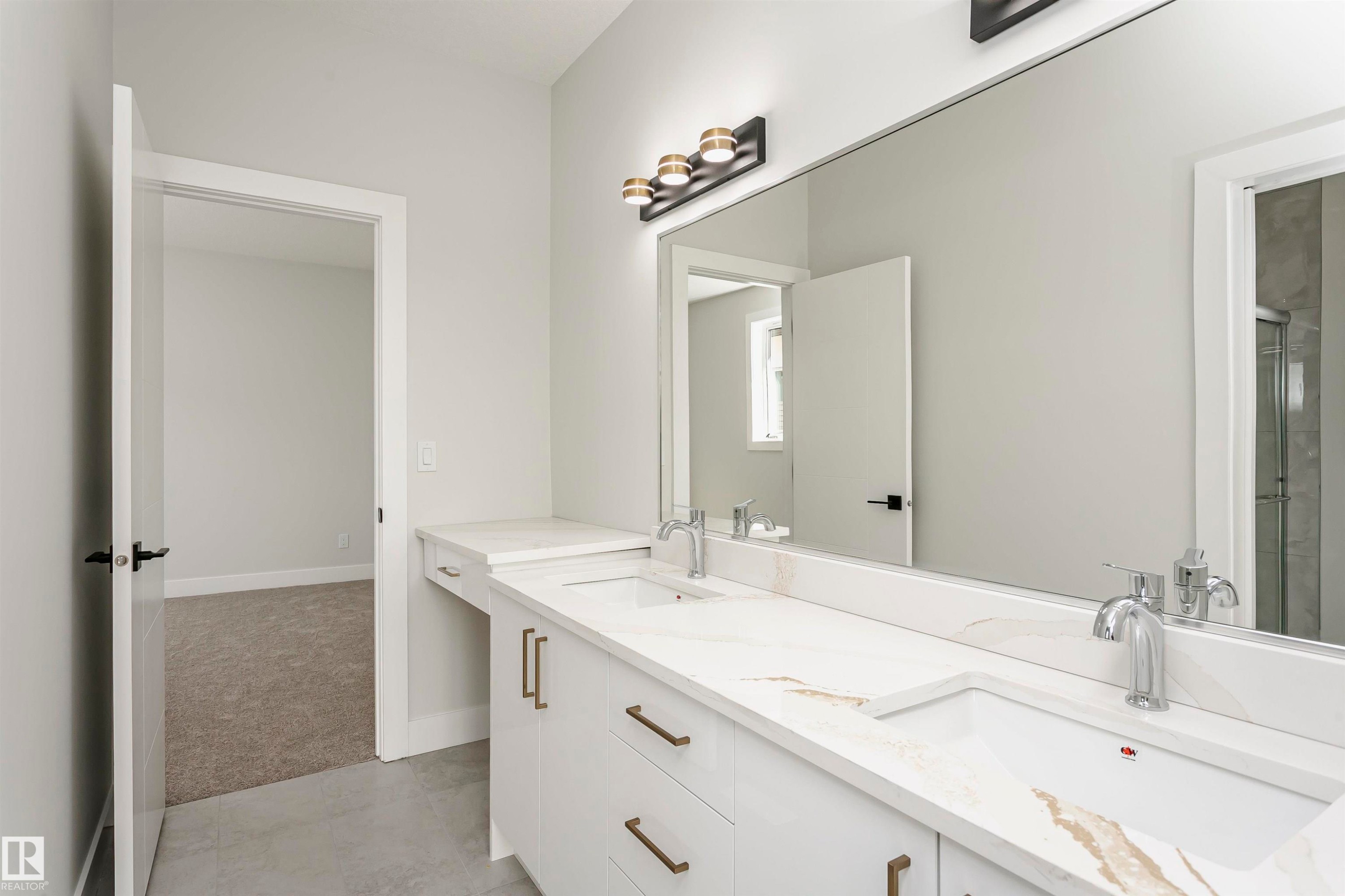 Bathroom with light colored carpet, double vanity, an enclosed shower, and light tile patterned flooring - 1723 19 Street, Edmonton, AB - Indoor Photo Showing Bathroom